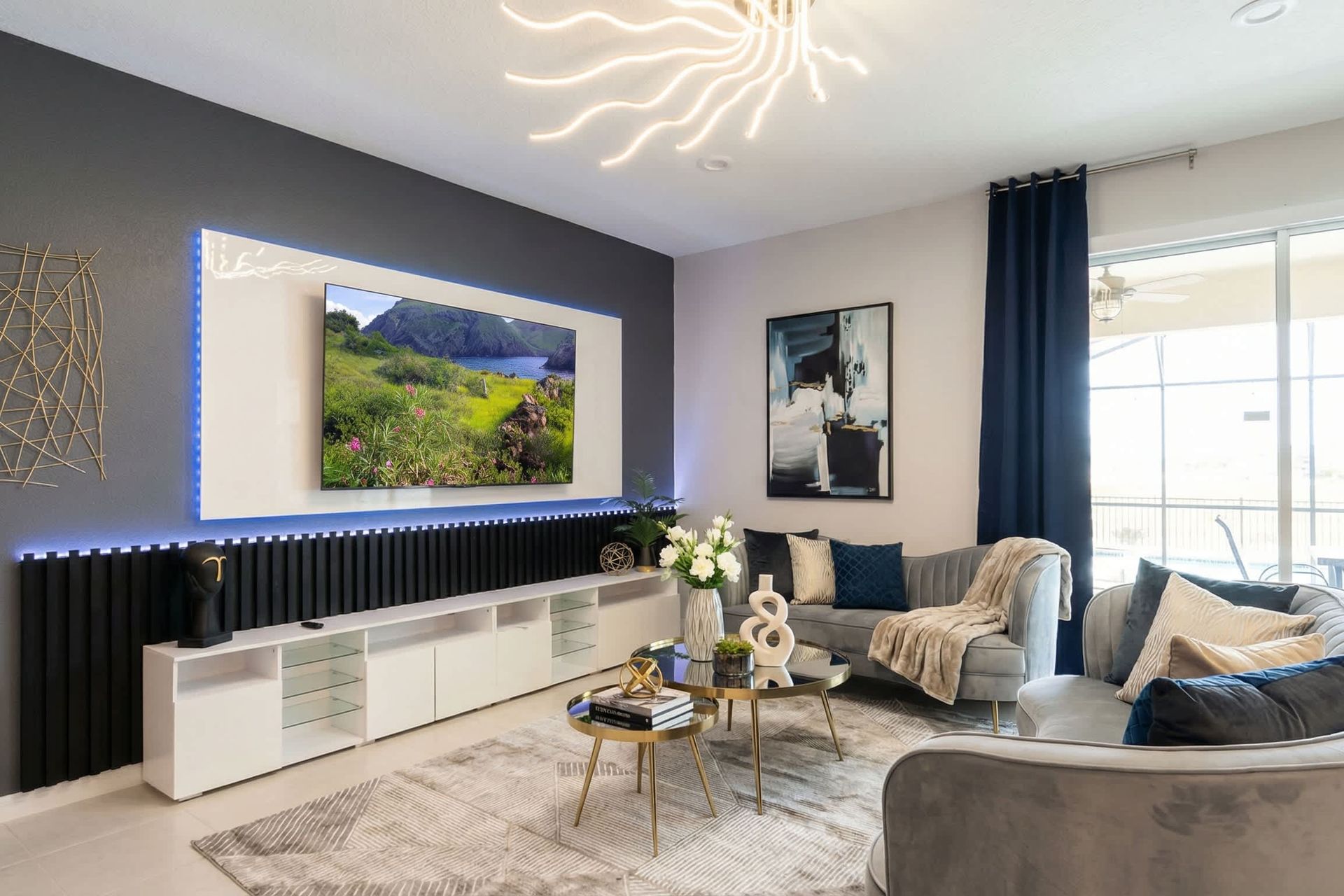 Chic modern living room with sleek decor, LED accents, and poolside views.
