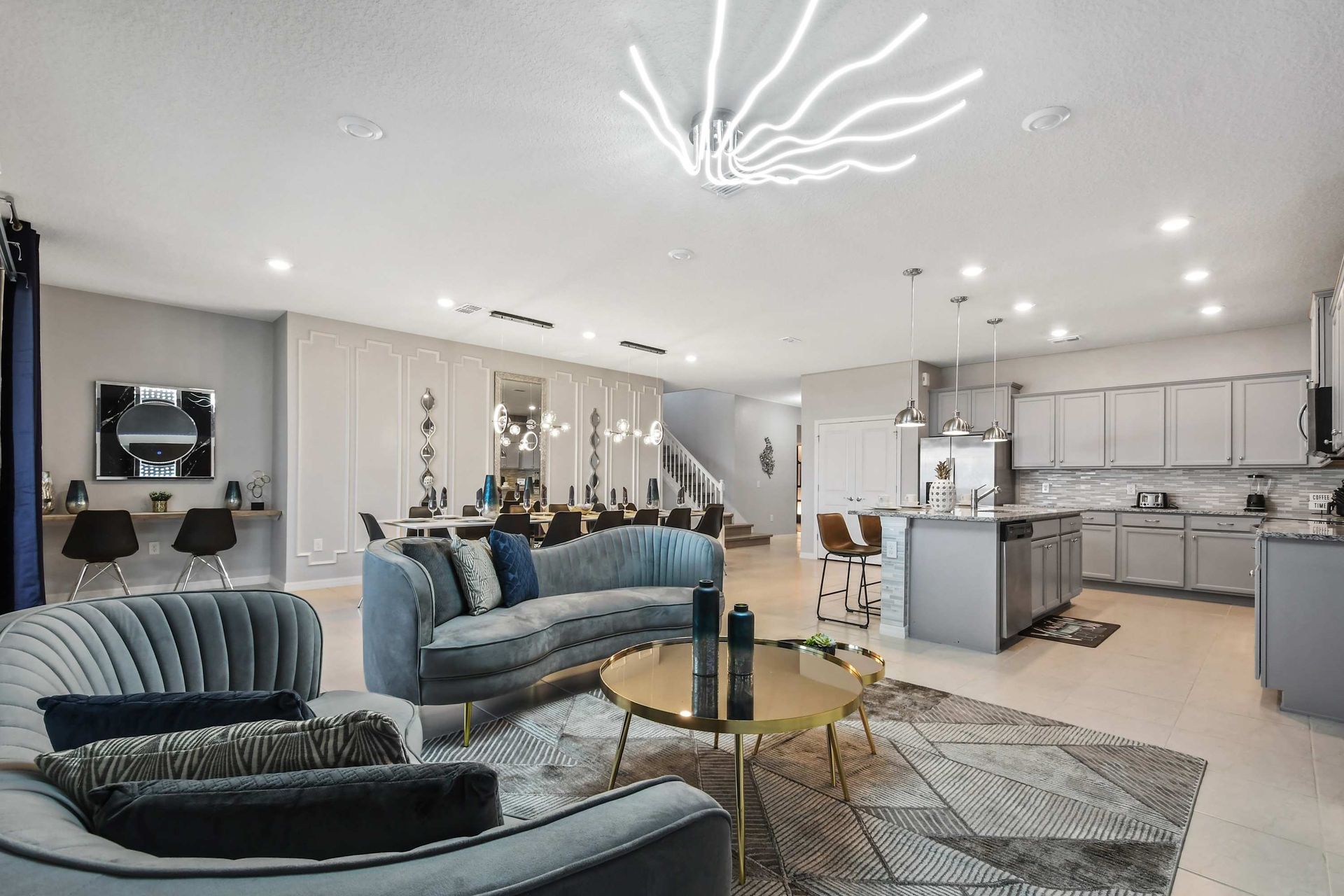 Spacious open-concept living with designer kitchen, luxe lounge, and dining area.