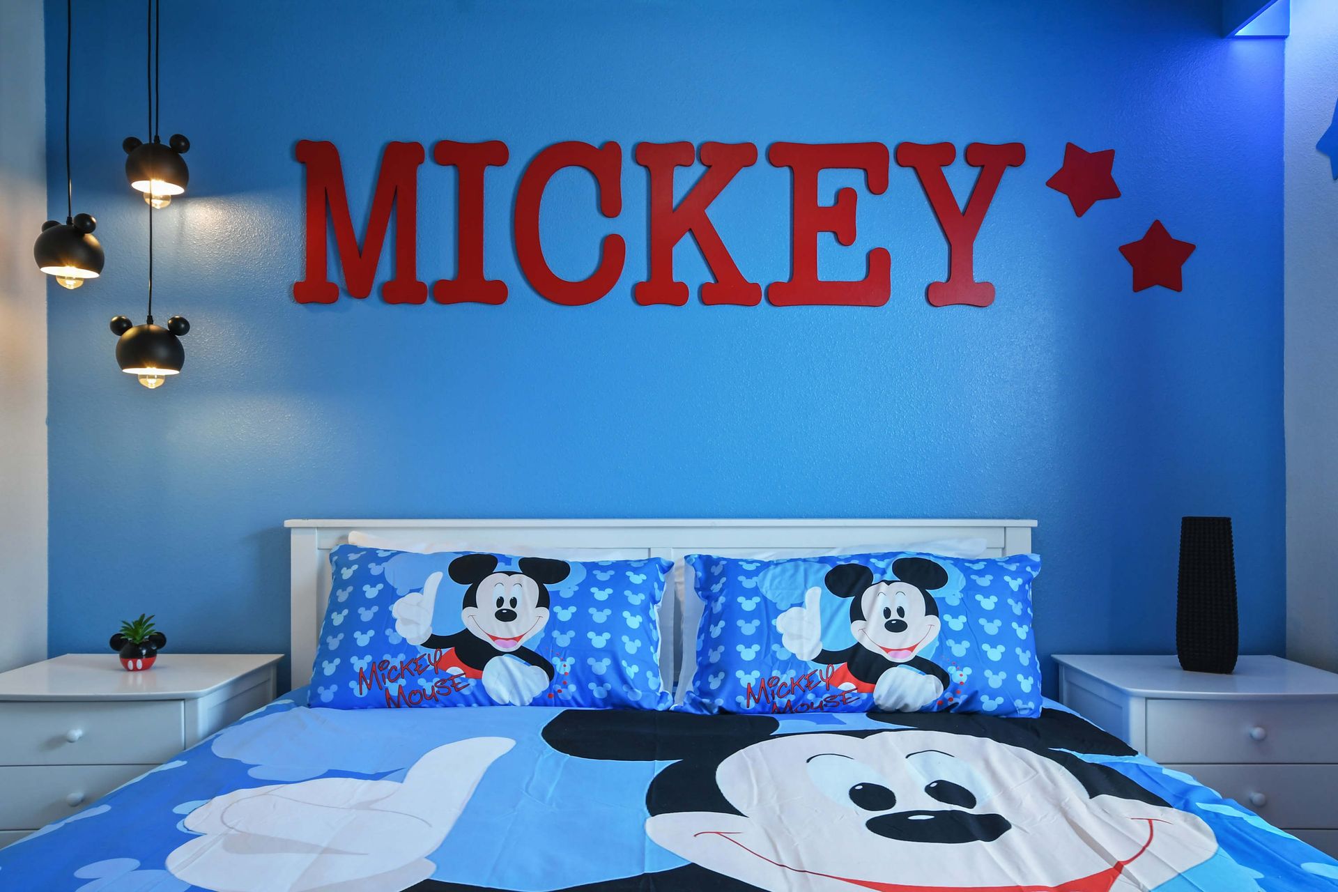 Fun Mickey-themed kids room with bold colors, cozy bedding, and playful charm.
