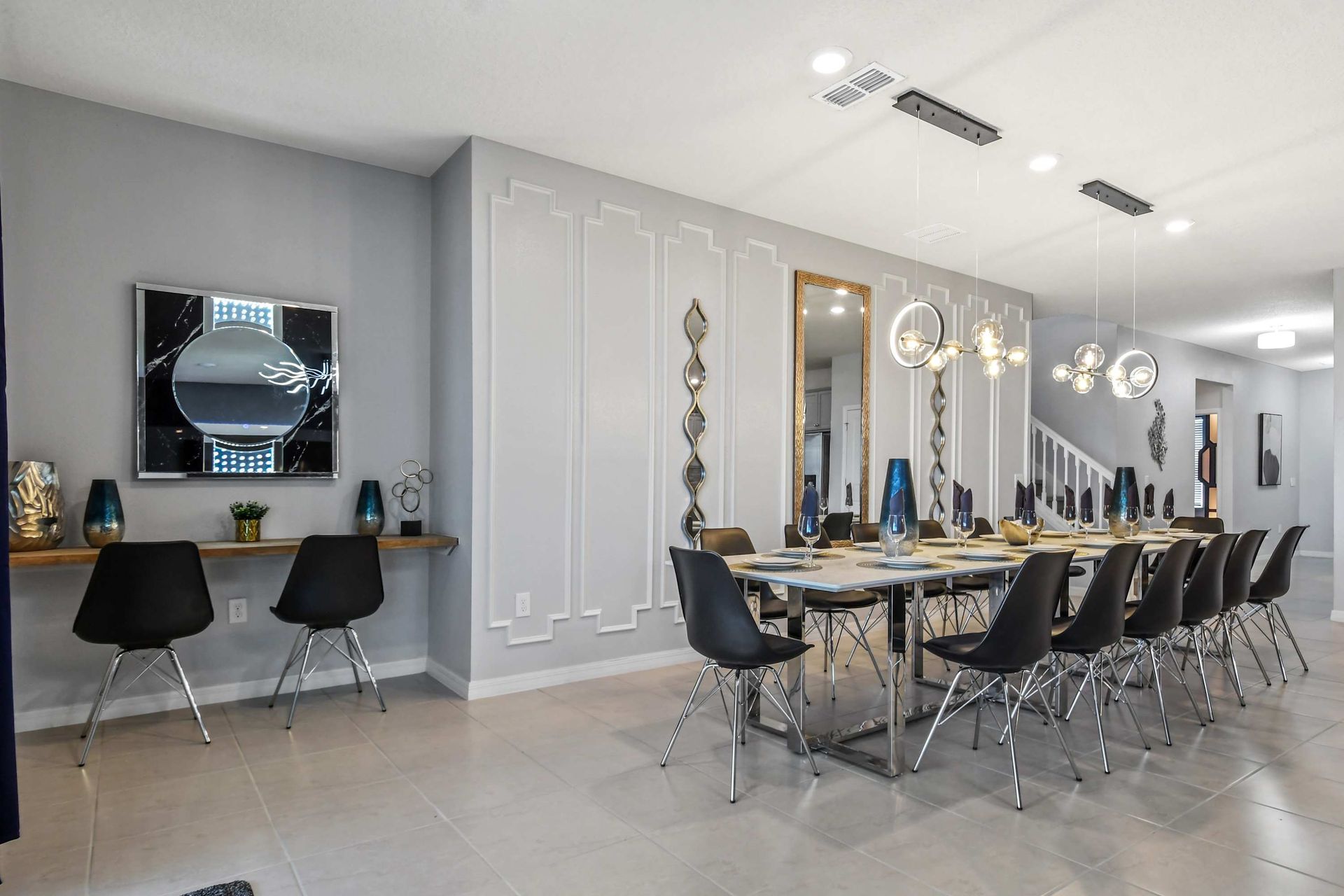 Elegant dining area with seating for 12, modern lighting, and a chic workspace.