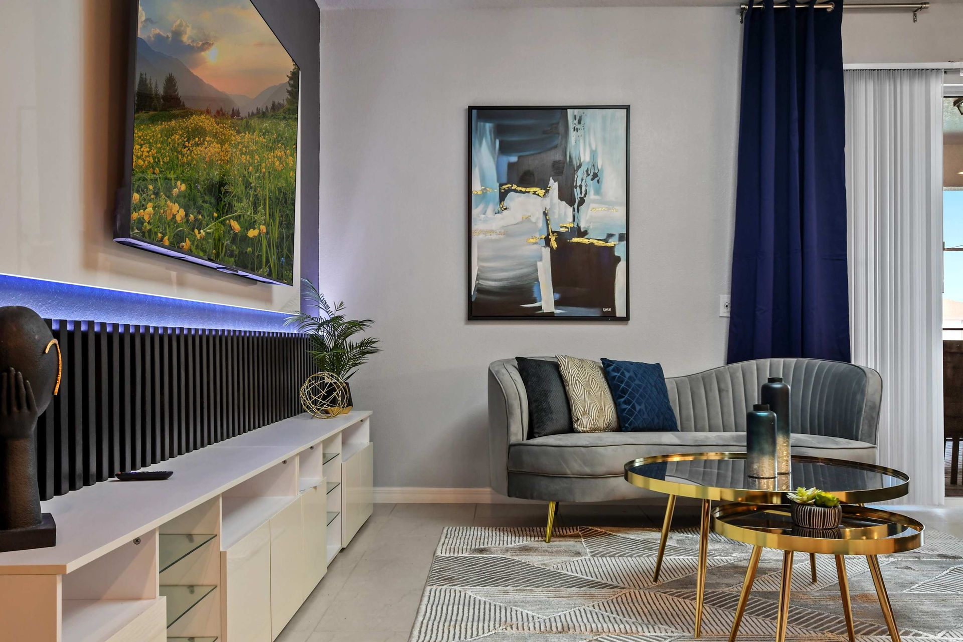 Stylish lounge with velvet seating, gold accents, and a sleek entertainment setup.