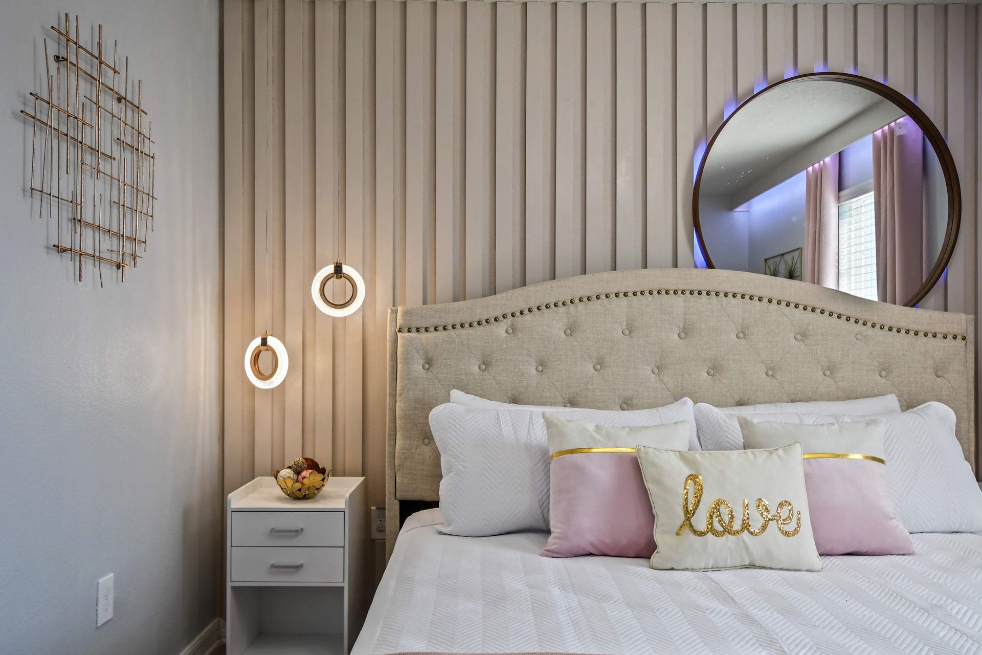 Romantic retreat with soft blush tones, modern lighting, and elegant décor touches.