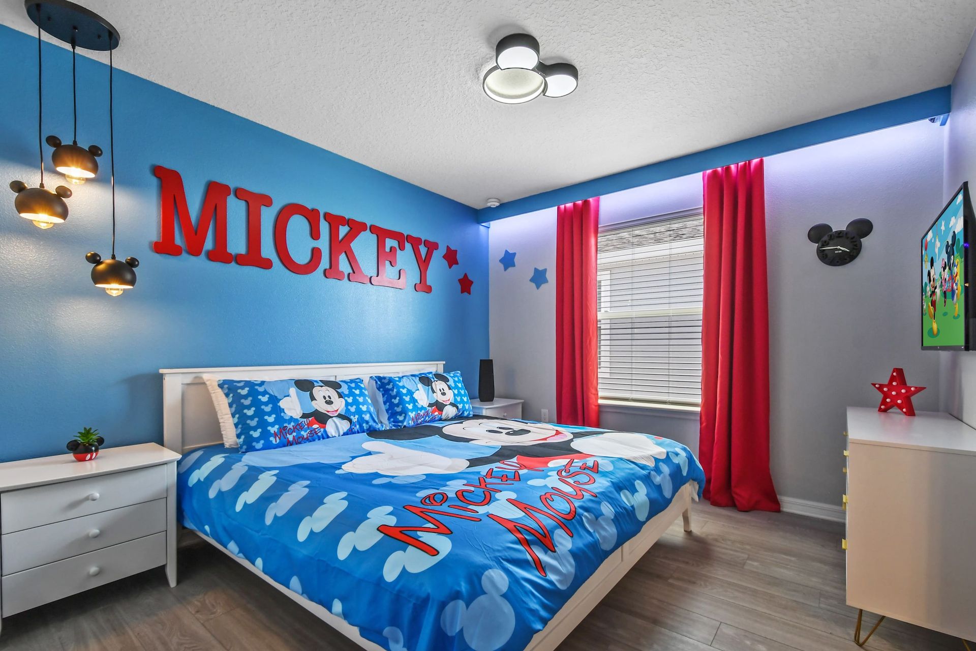Vibrant Mickey-themed bedroom with playful decor, fun lighting, and cozy vibes.
