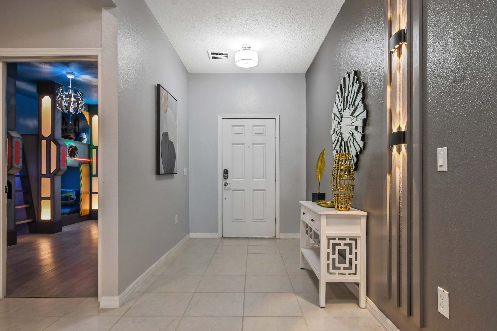 Stylish entryway with modern decor welcomes you to a fun and luxurious stay.