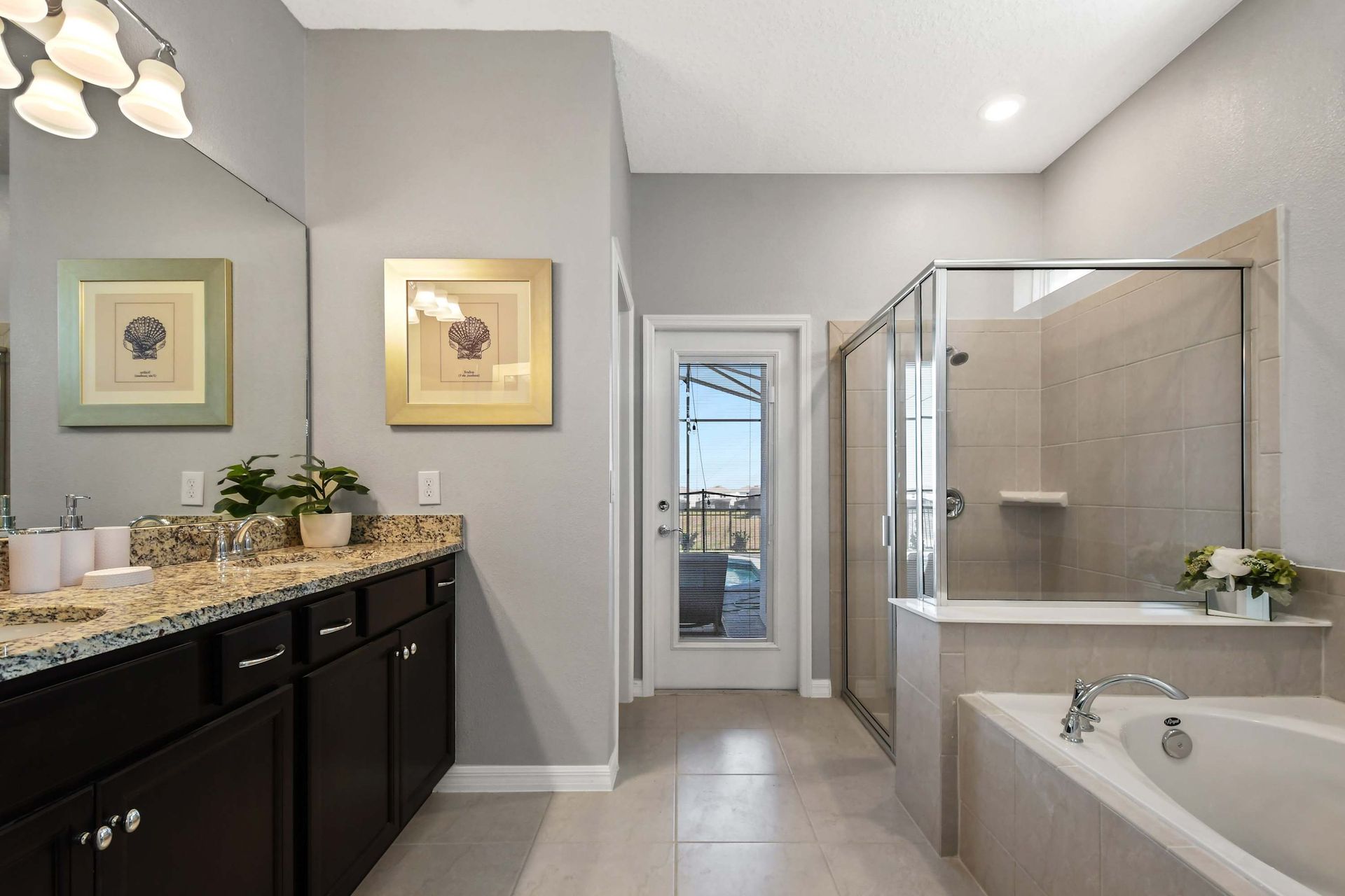 Elegant ensuite with soaking tub, walk-in shower, and private poolside access.