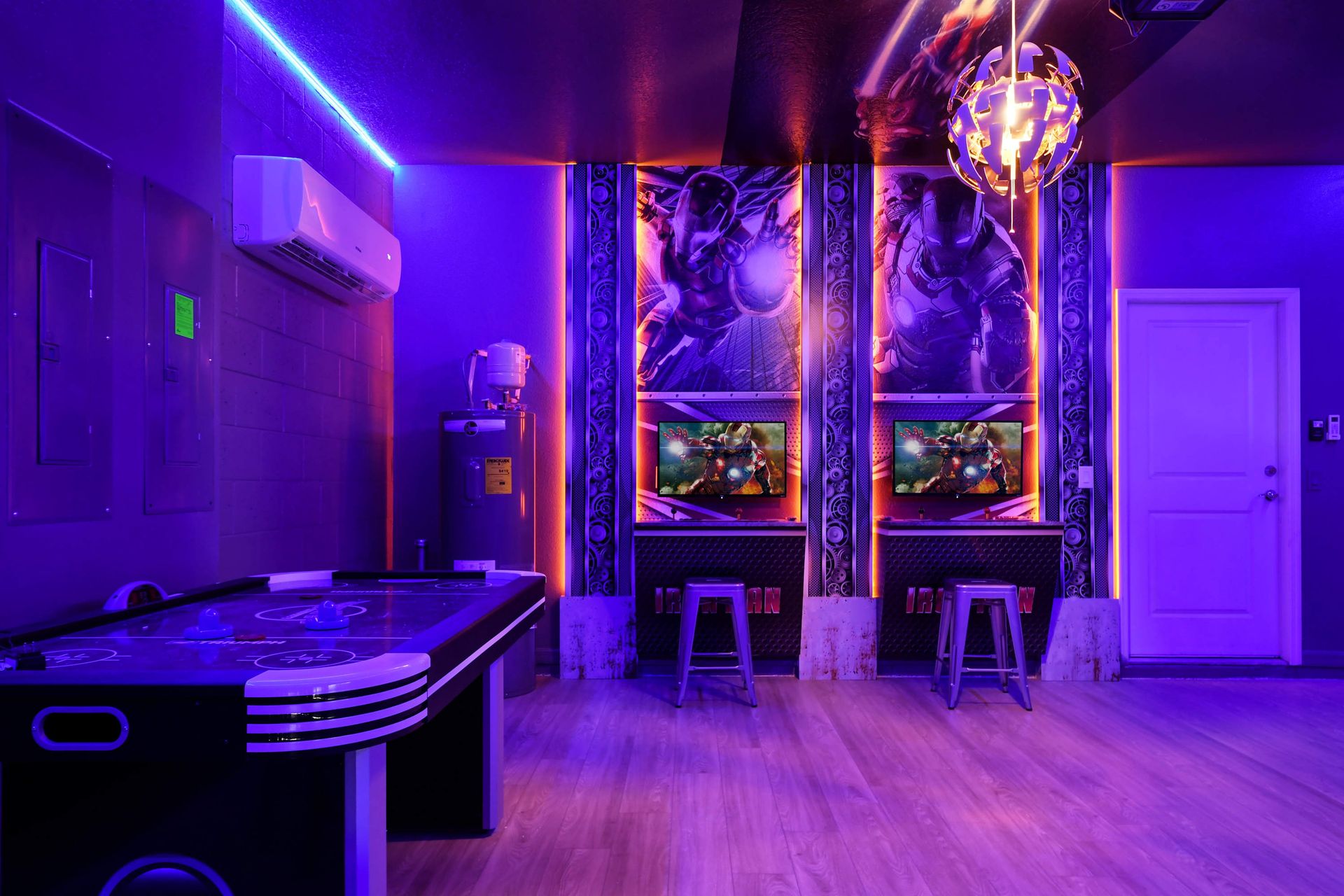 Superhero-themed game room with dual gaming stations and air hockey fun!
