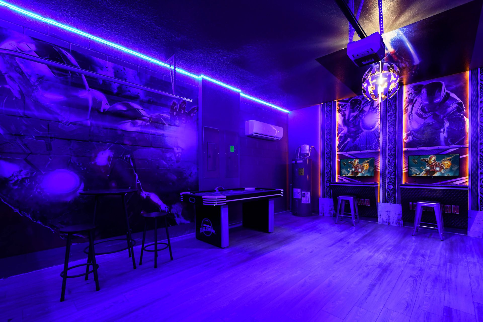 High-energy Iron Man arcade with glowing lights, gaming stations, and air hockey fun.
