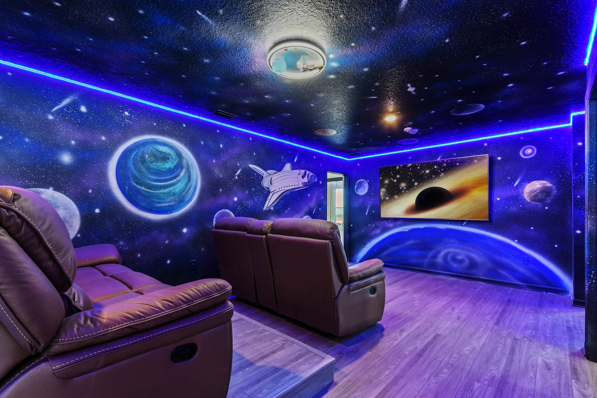 Immersive galaxy-themed theater with recliners, LED lighting, and epic vibes.