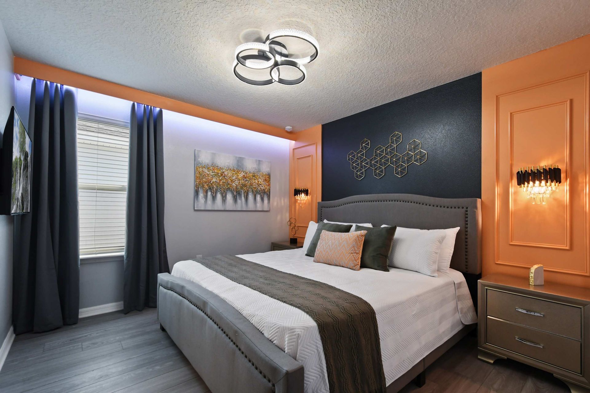 Stylish bedroom with bold accent walls, modern lighting, and luxe cozy bedding.