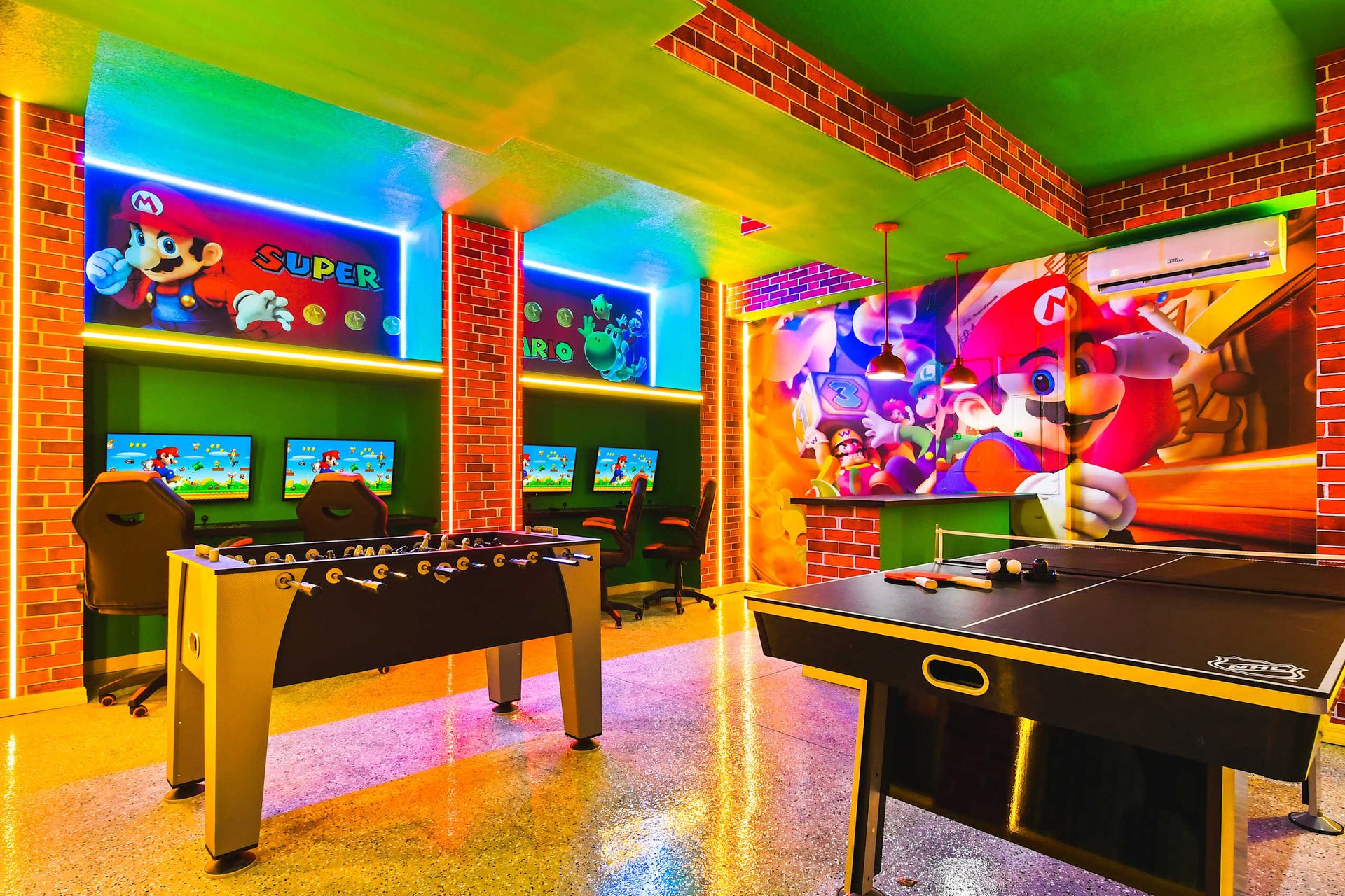Retro Mario-themed game room with PCs, foosball, and ping-pong for endless fun.