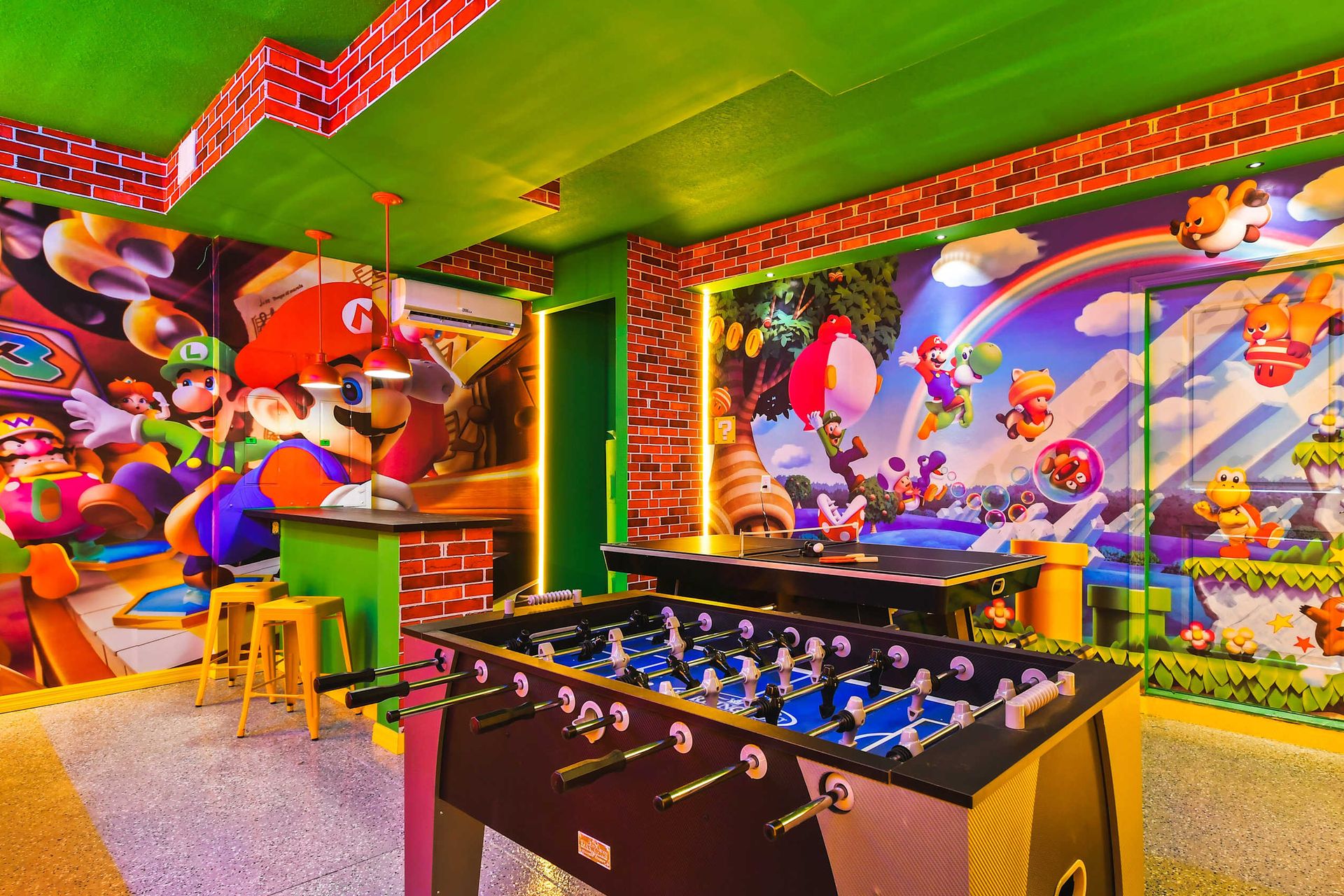 Mario-themed game room with vibrant murals, foosball, and ping-pong for all ages.