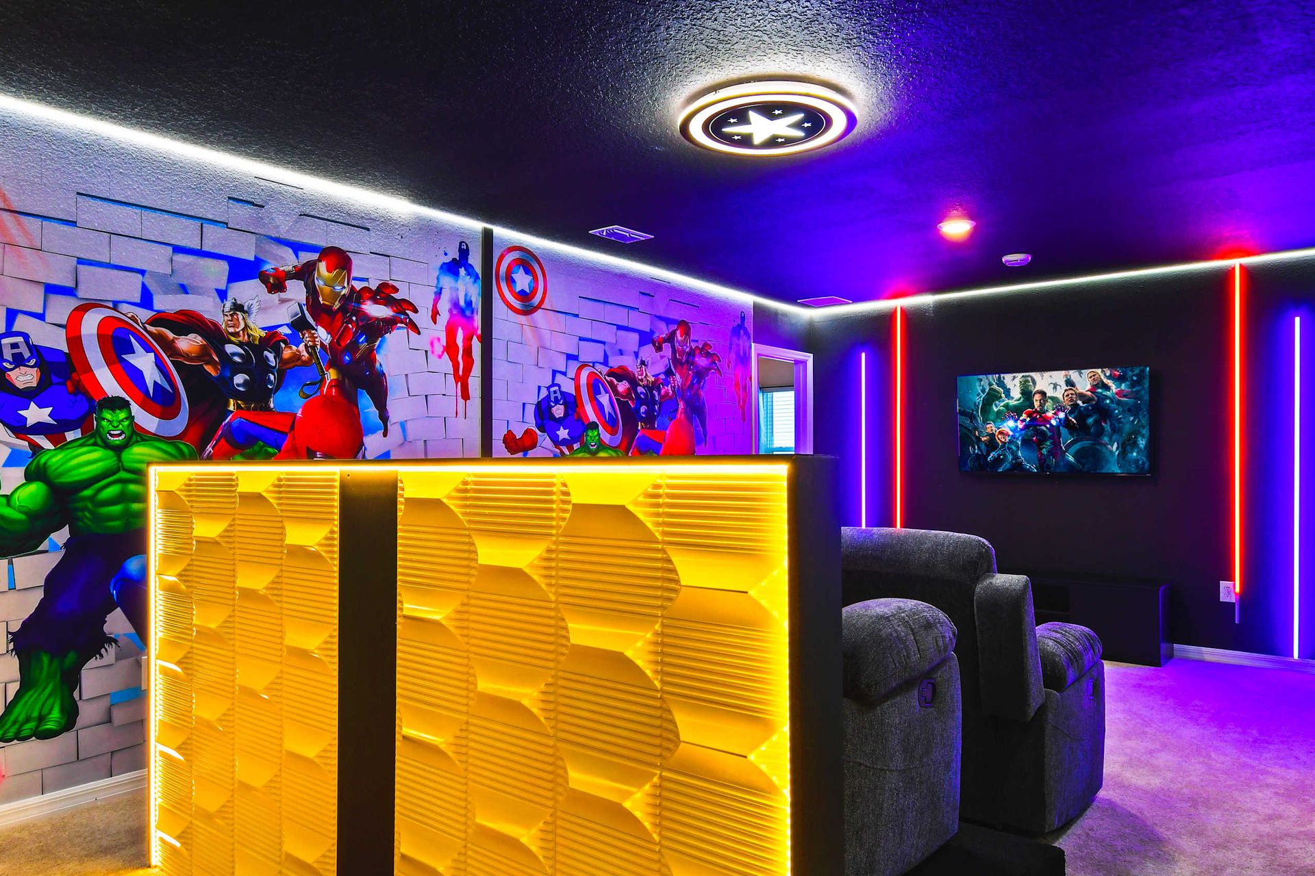 Avengers-themed home theater with neon lights and recliners for epic movie nights.