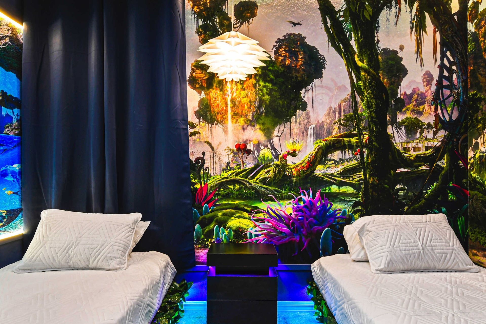 Avatar-themed bedroom with glowing murals, nature-inspired decor, and twin beds.
