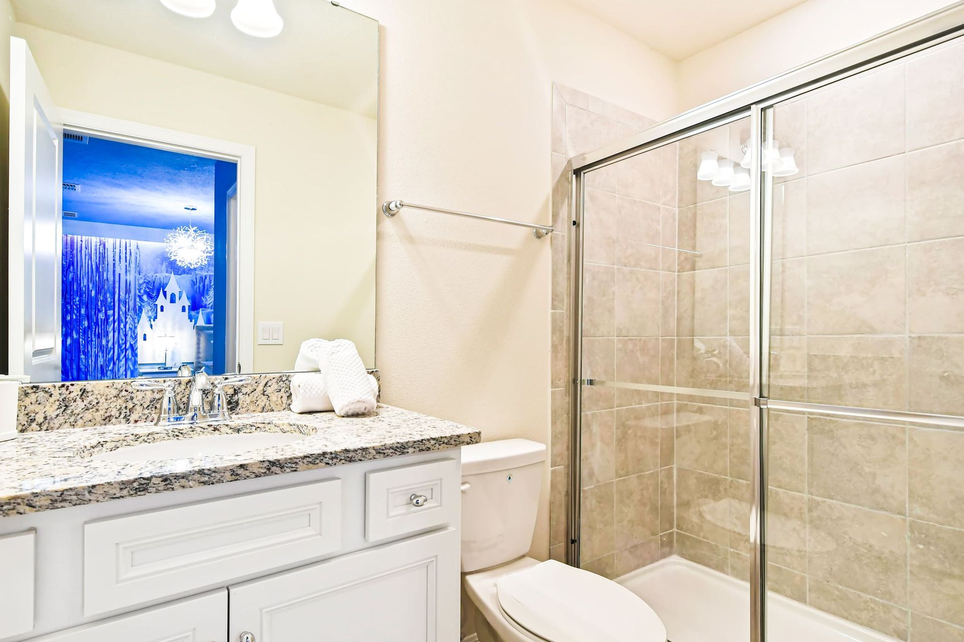 Stylish bathroom with granite double sinks, large shower, and sleek modern design
