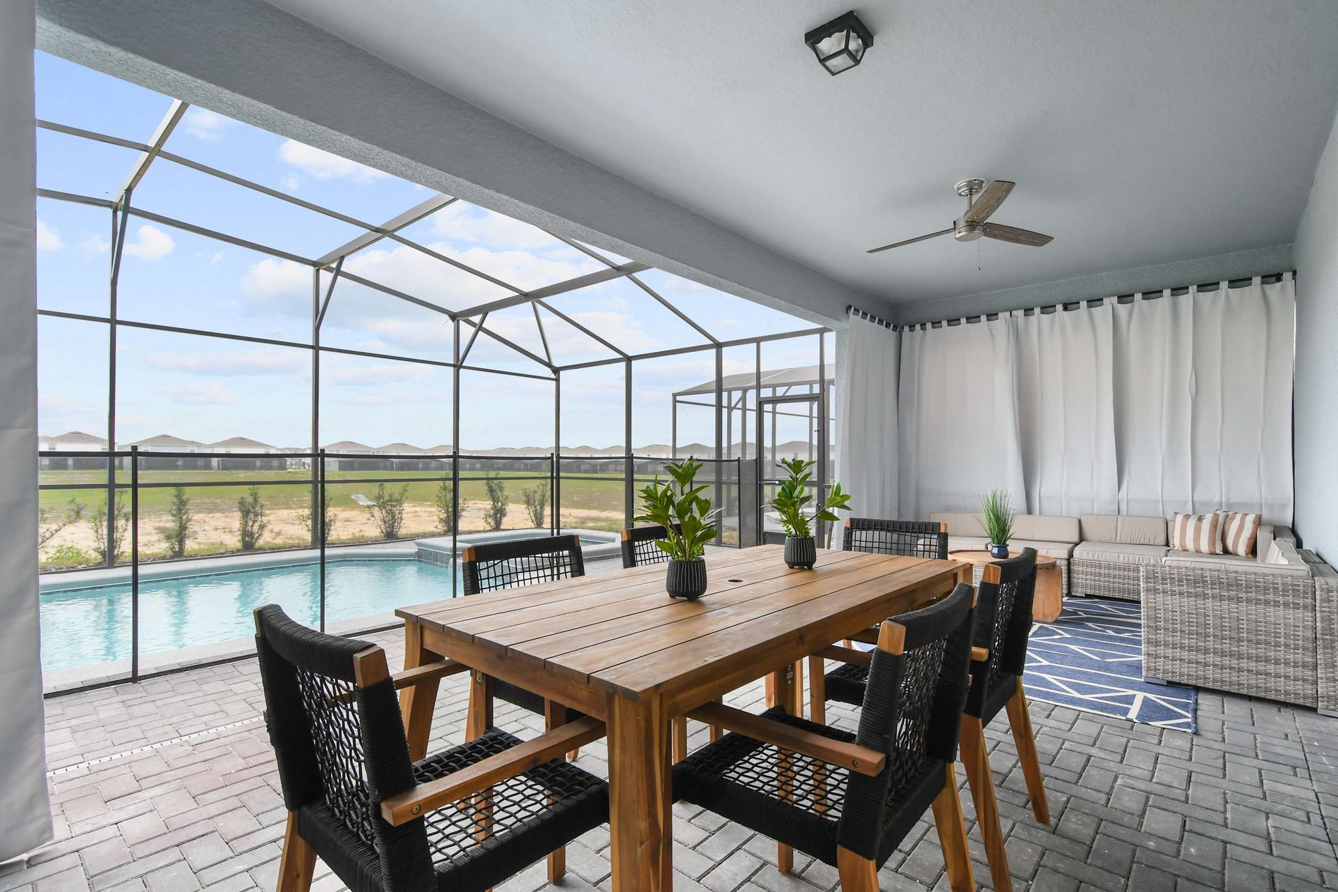 Relax in style with a private pool, covered patio, and cozy outdoor seating area.
