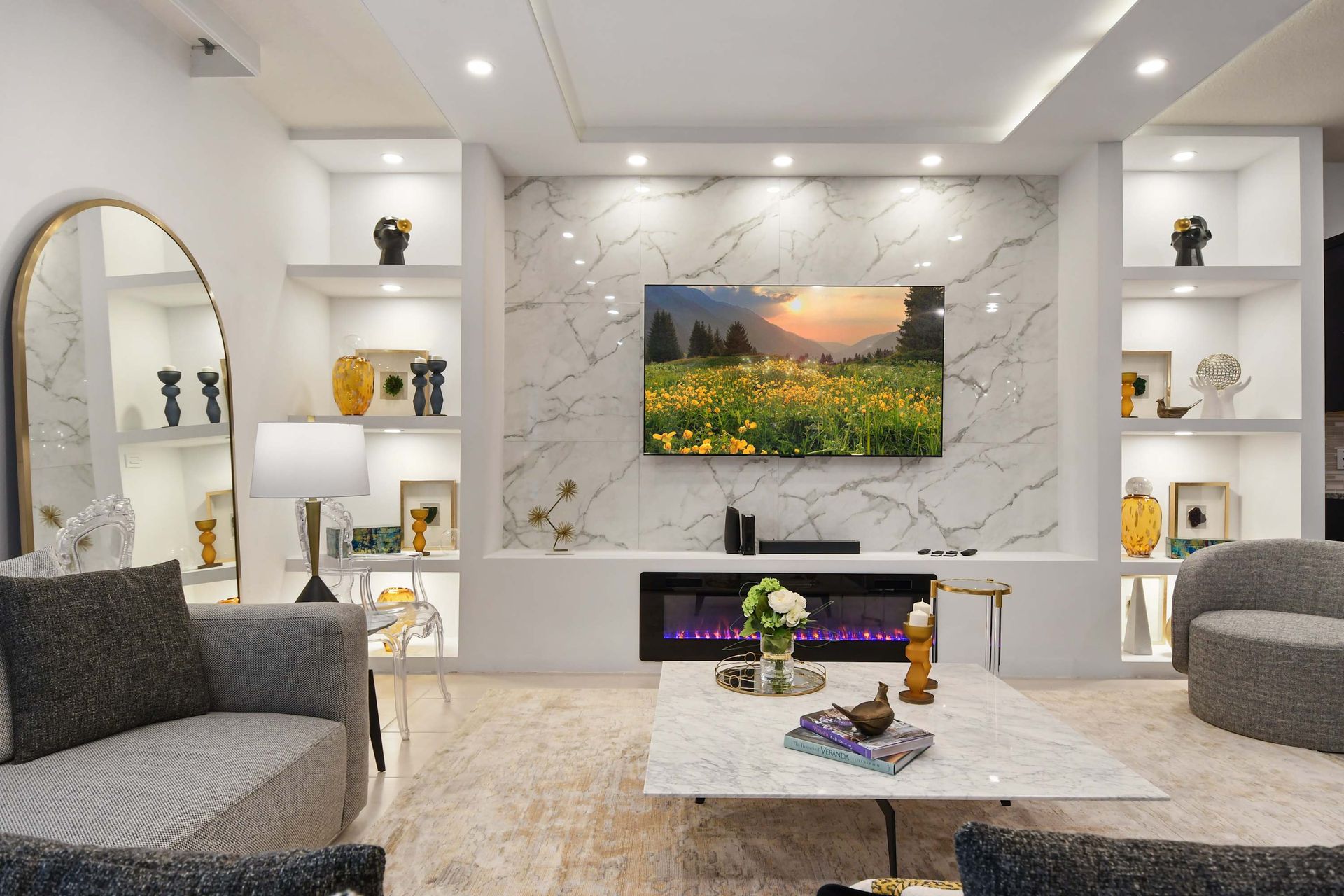 Sleek living room with marble accents, fireplace, and built-in modern shelving.
