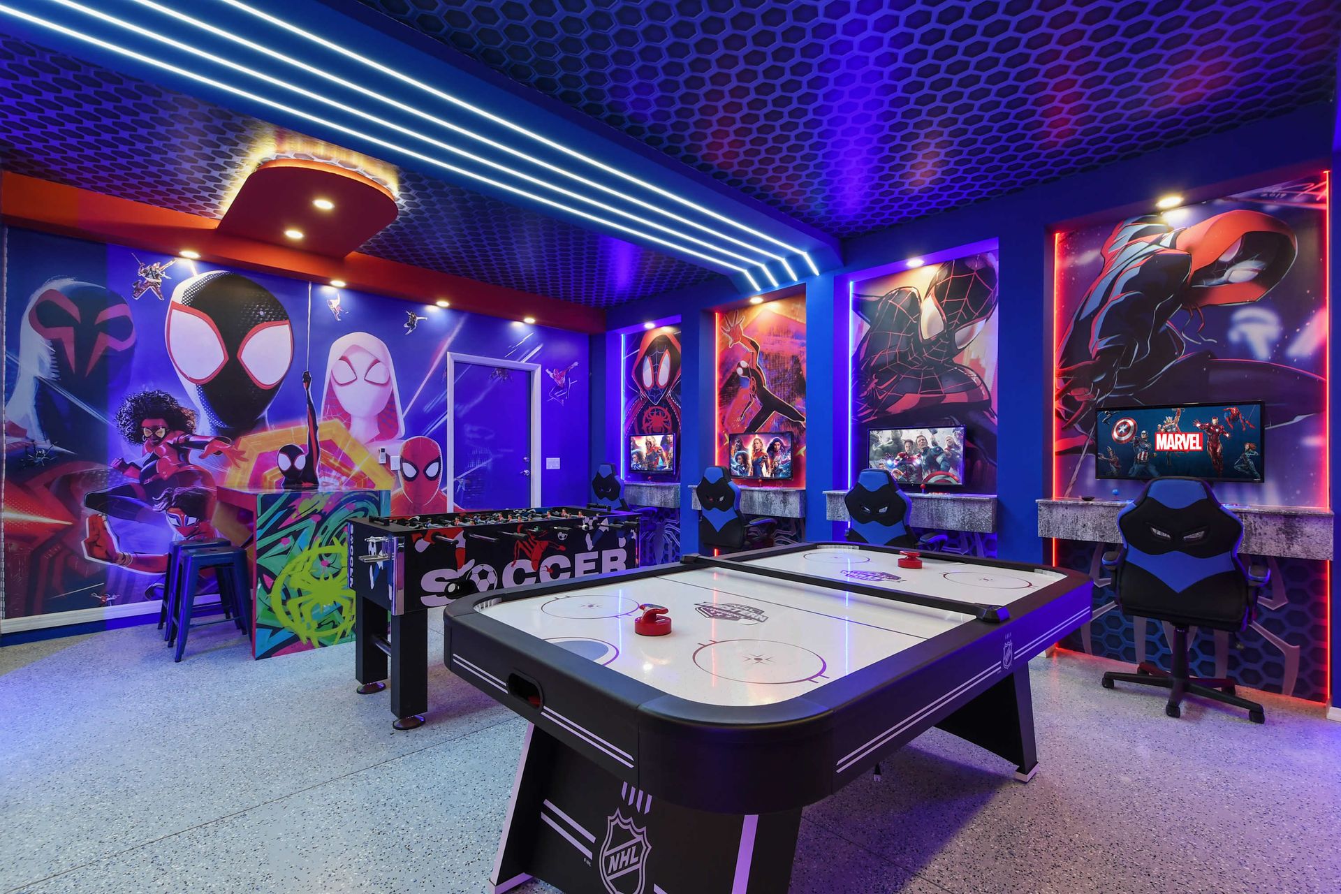 Spider-Verse themed game room with air hockey, foosball, and dual gaming stations.