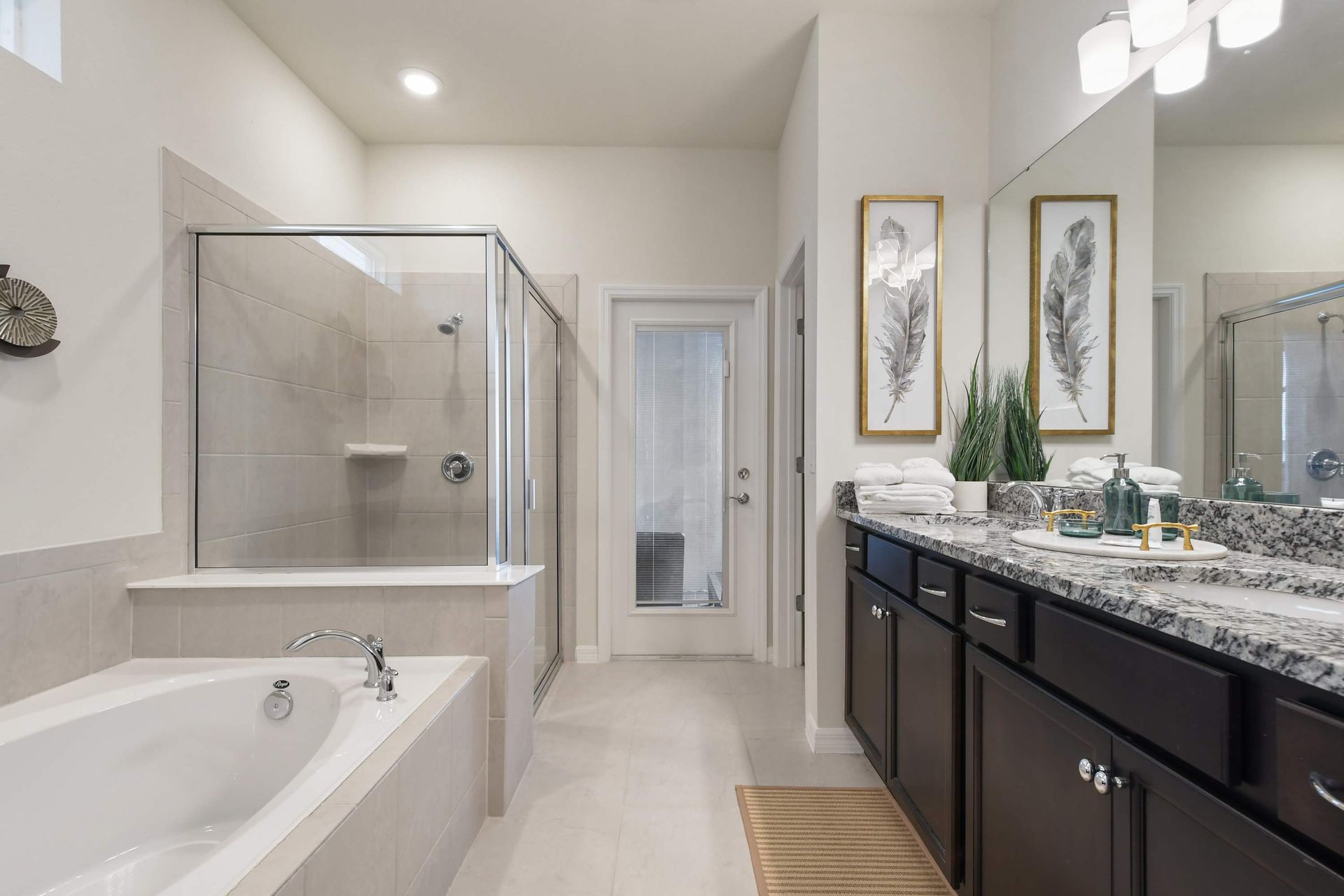 Luxurious bathroom with double vanity, walk-in shower, and relaxing soaking tub.
