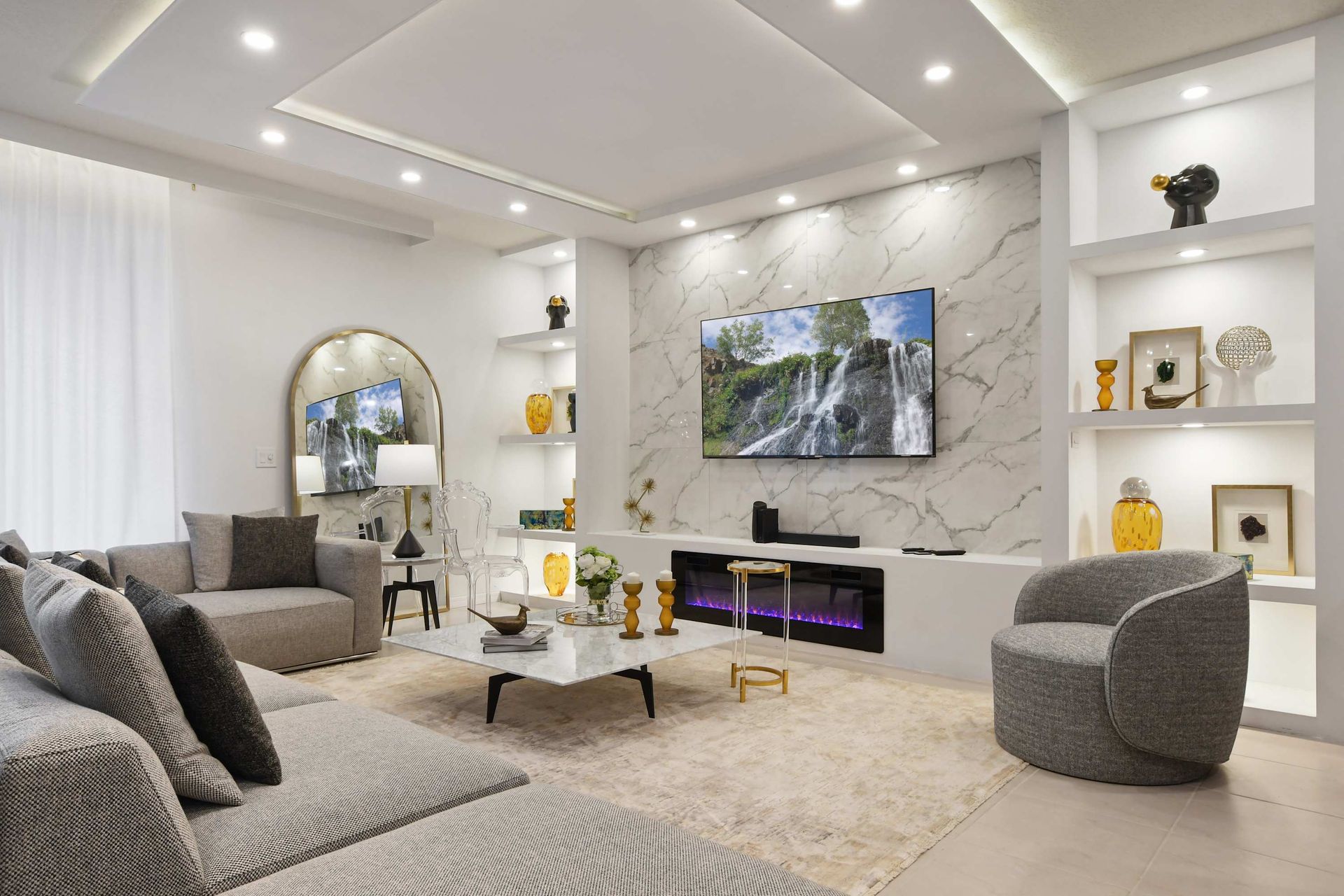 Contemporary lounge with marble finishes, electric fireplace, and designer seating.