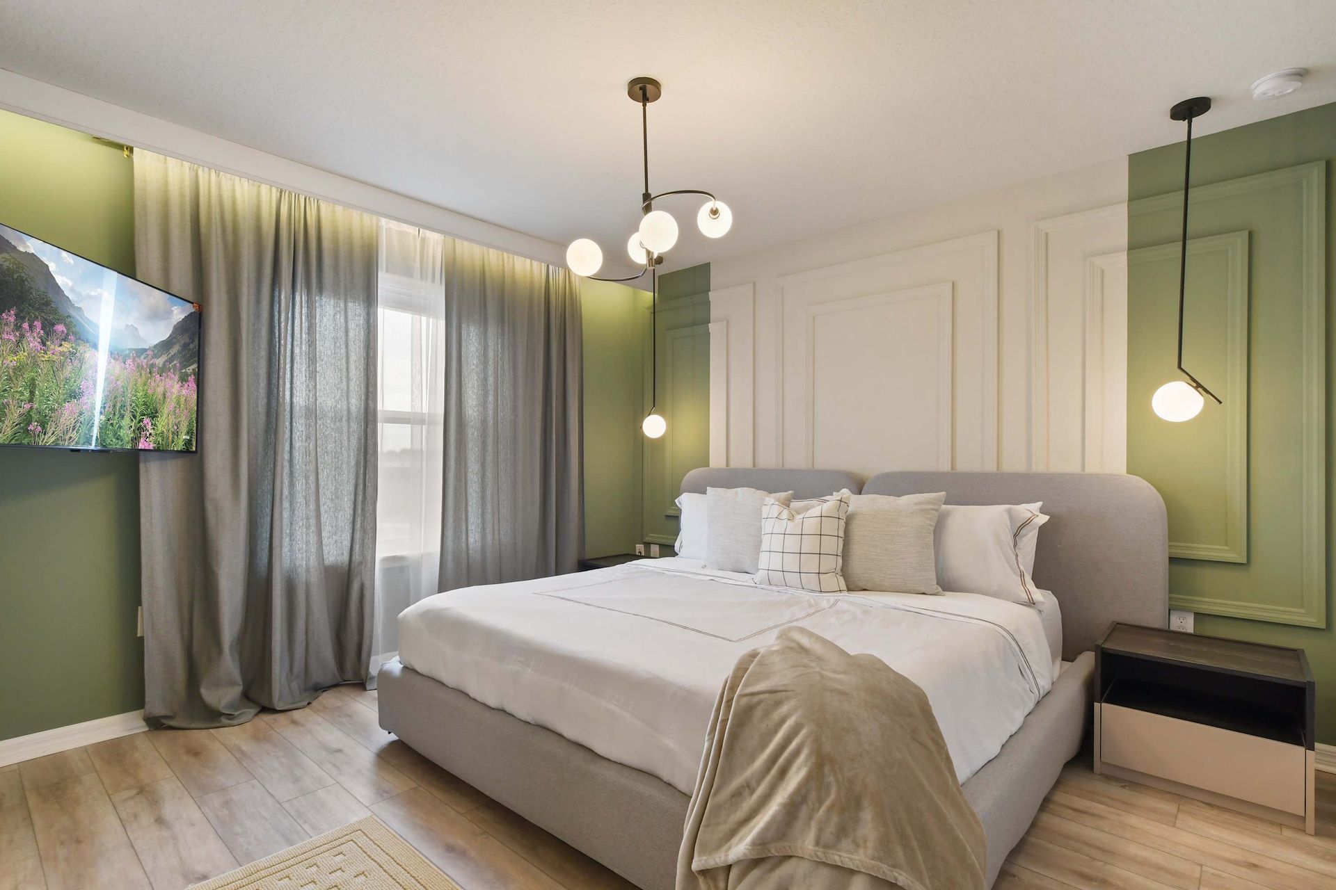 Elegant retreat with sage green accents, luxe king bed, and soft ambient lighting.