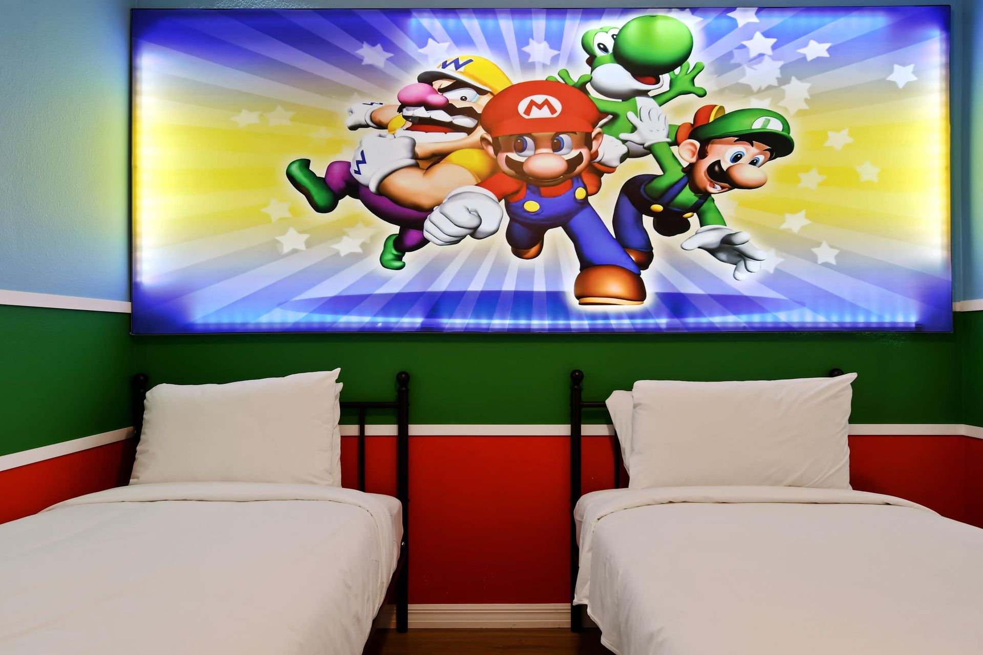 Colorful gaming-themed room with twin beds, perfect for kids and fun vibes.