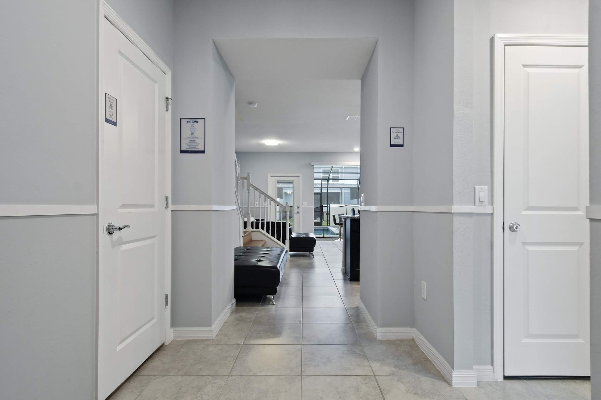 Bright and welcoming entryway with modern tile flooring and open-concept design.