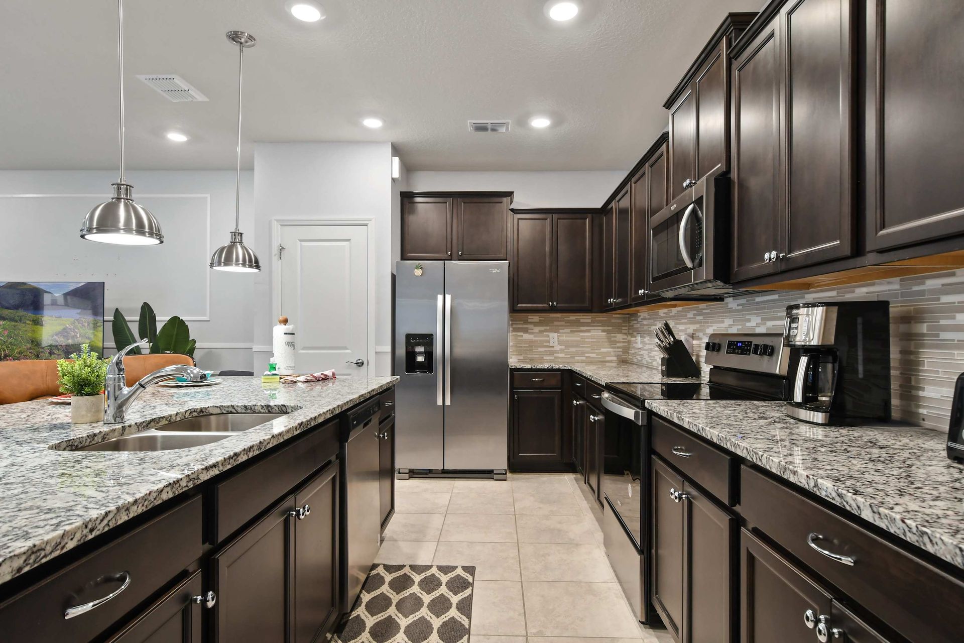 Fully equipped chef’s kitchen with granite counters and stainless steel appliances.