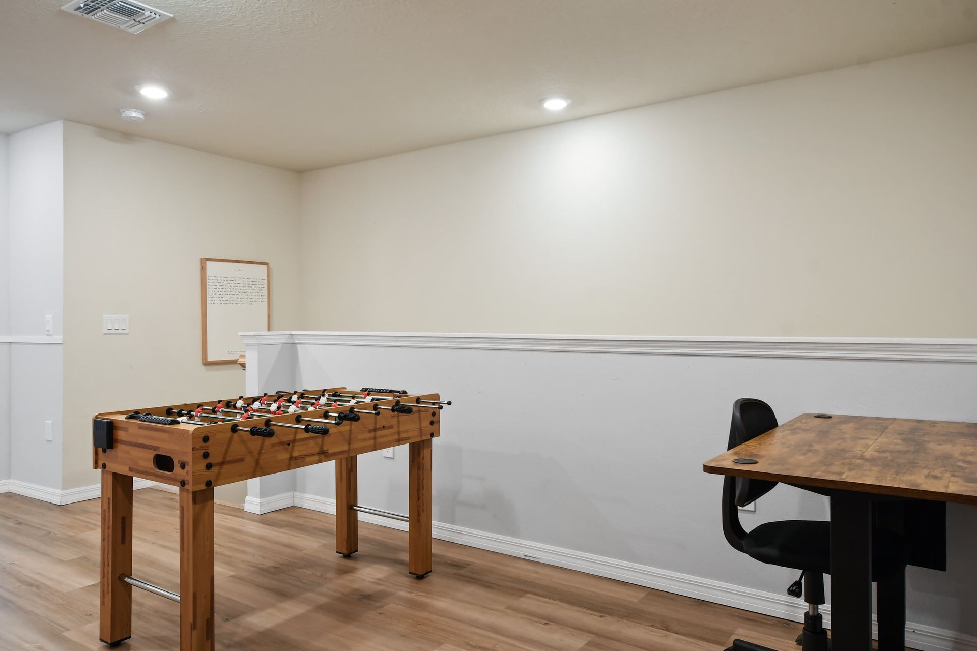 Upstairs nook with foosball table and desk—ideal for play or productivity.