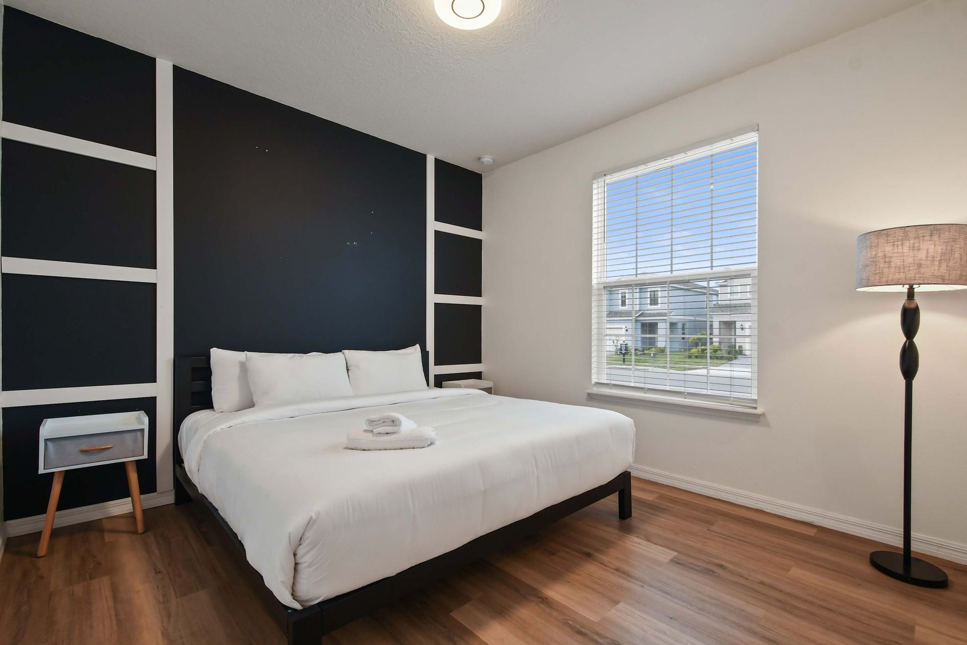 Modern, stylish bedroom with king bed, natural light, and cozy ambiance.