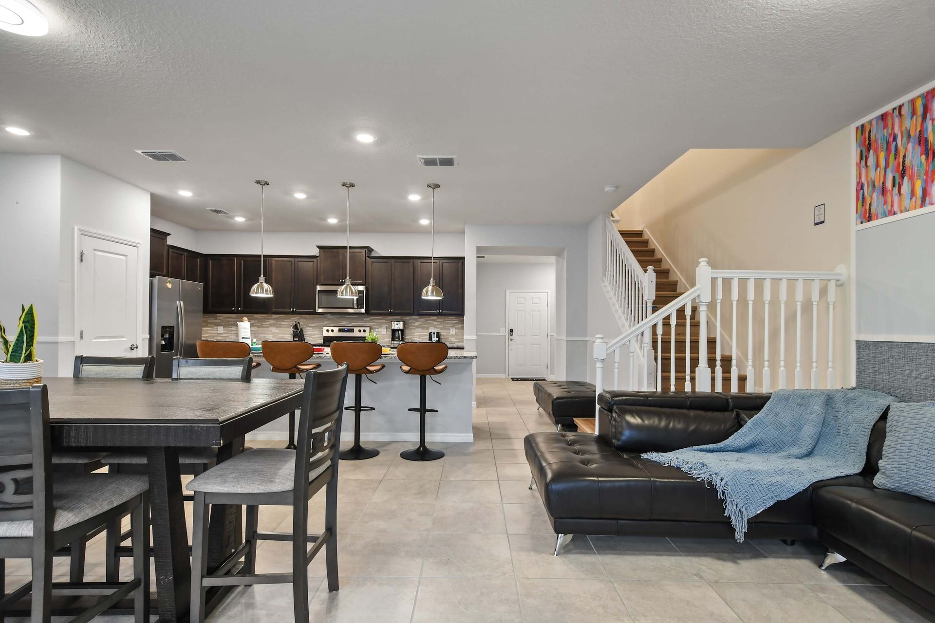 Stylish open-concept living with gourmet kitchen, bar seating, and lounge area.