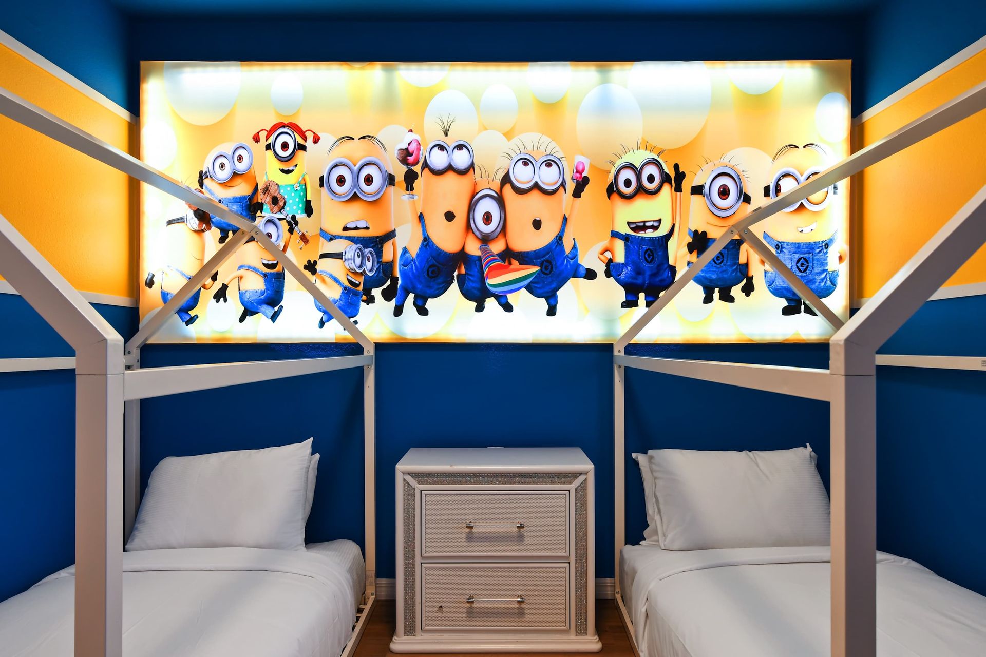 Fun-filled kids’ room with twin beds, vibrant colors, and playful themed decor.