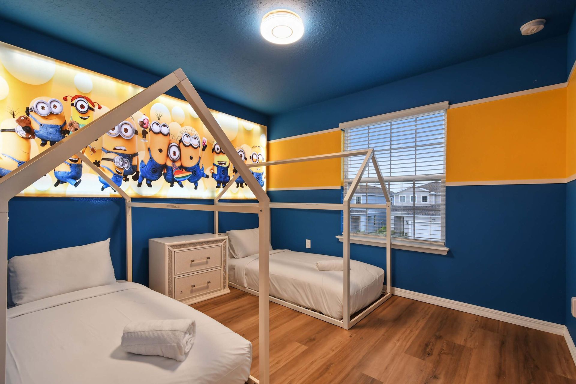 Minions-themed room with twin house-frame beds—perfect for little adventurers.
