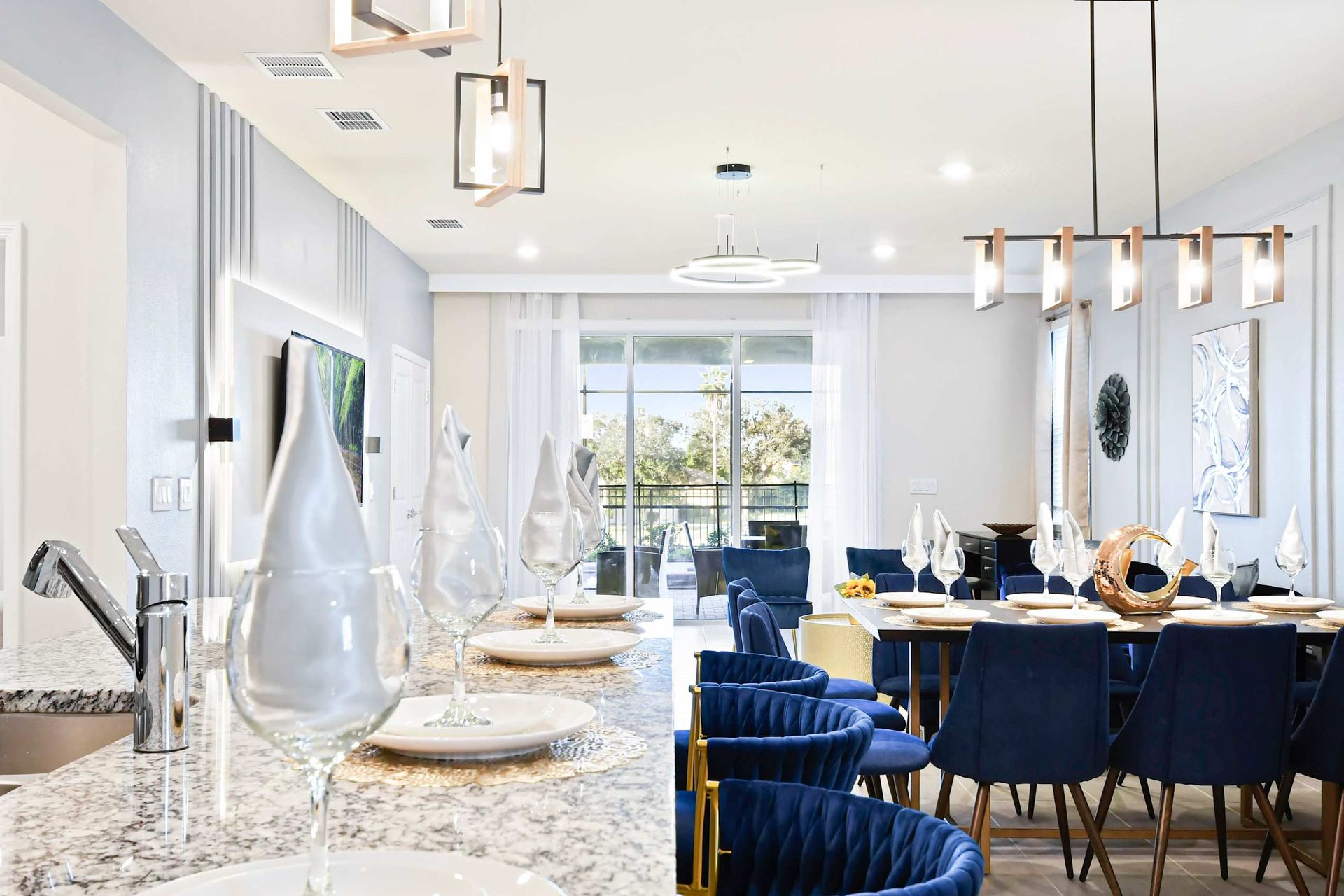 Sleek kitchen island with bar seating and open flow to stylish dining and patio.