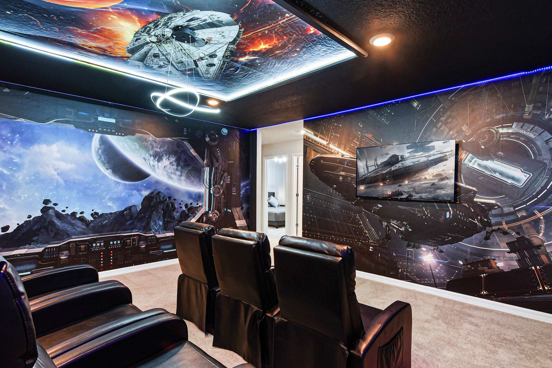 Immersive galaxy-themed theater room with recliners and epic sci-fi wall art.