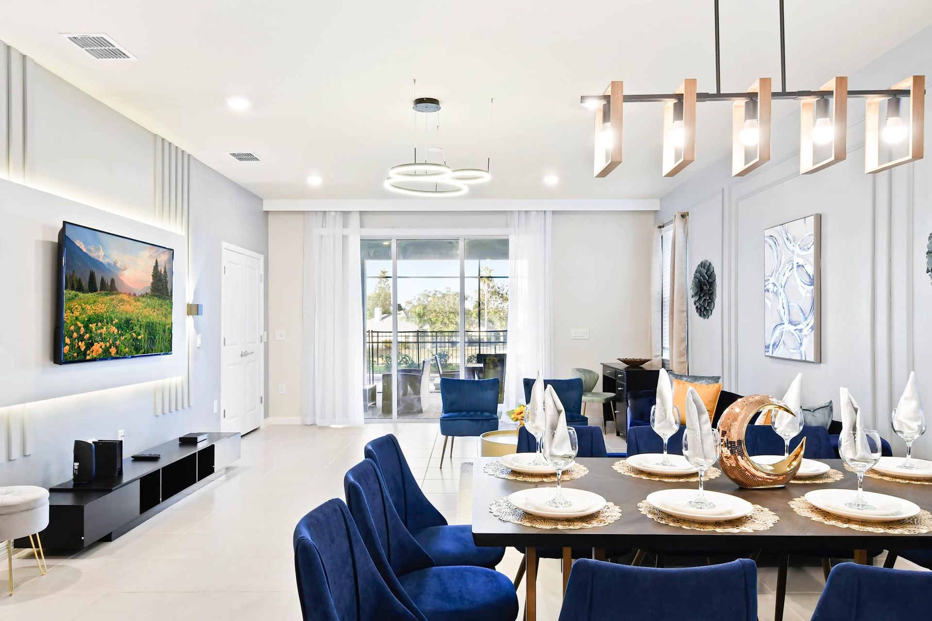 Bright and chic living space with elegant dining, plush seating, and patio views.