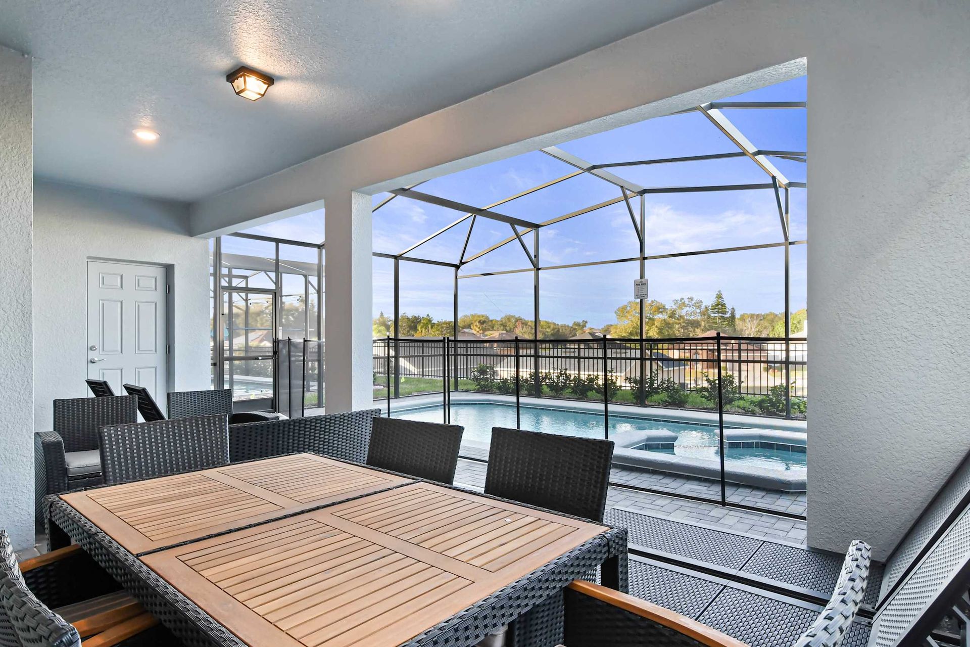 Relaxing screened patio with outdoor dining and private pool with spa views.
