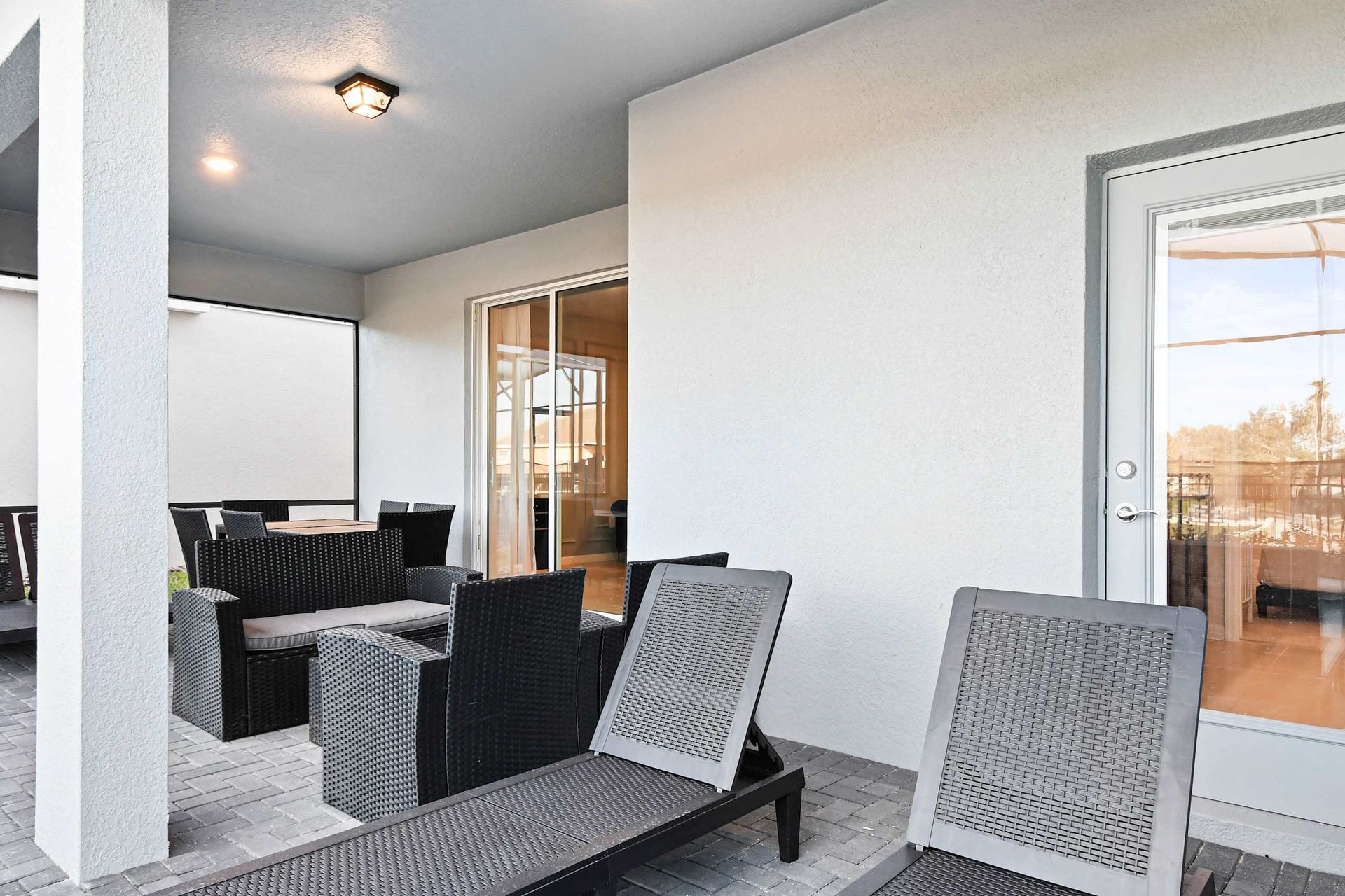 Relax in the shaded lanai with cozy seating and dining just steps from the pool.