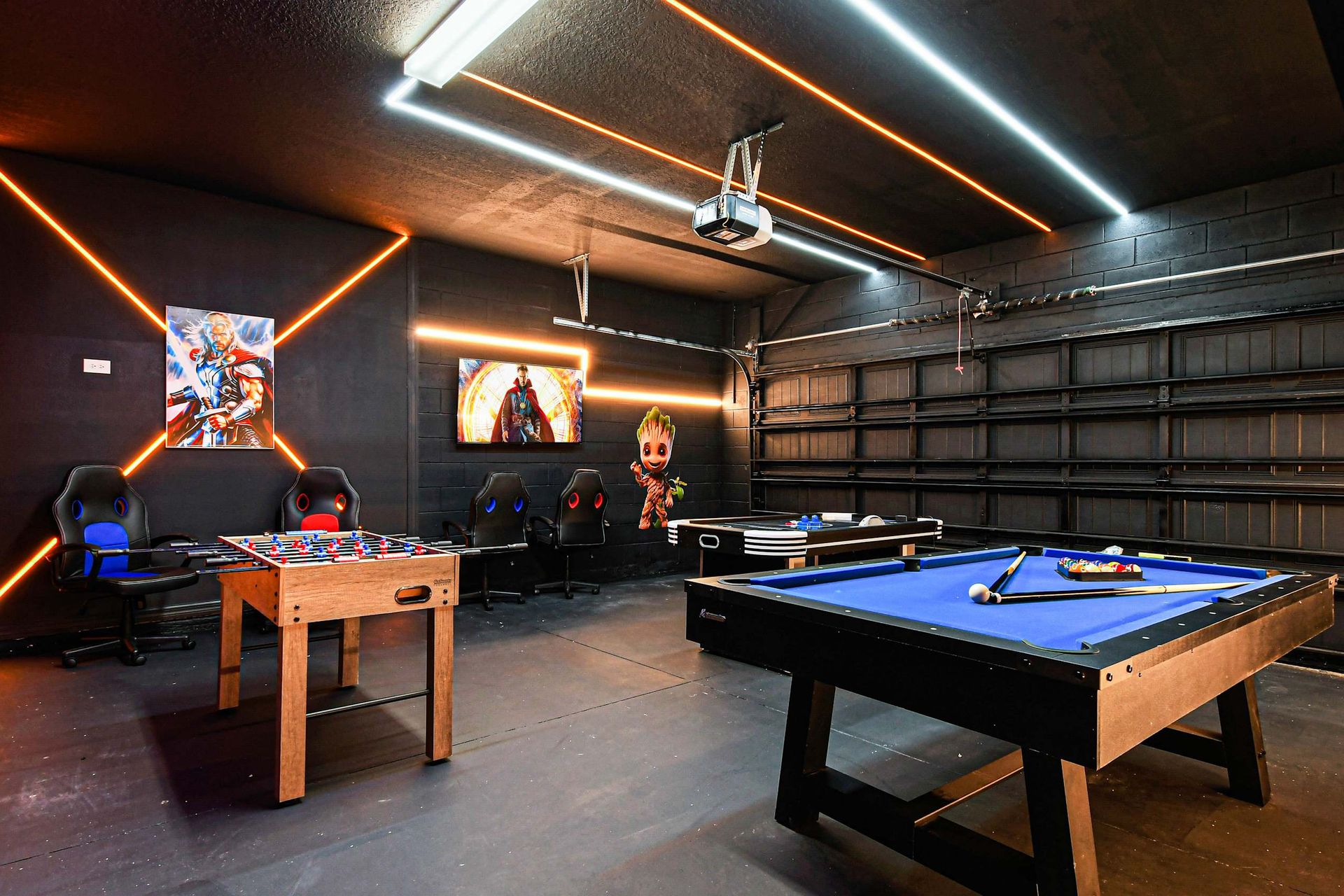 Action-packed superhero game room with foosball, pool, air hockey, and bold art.