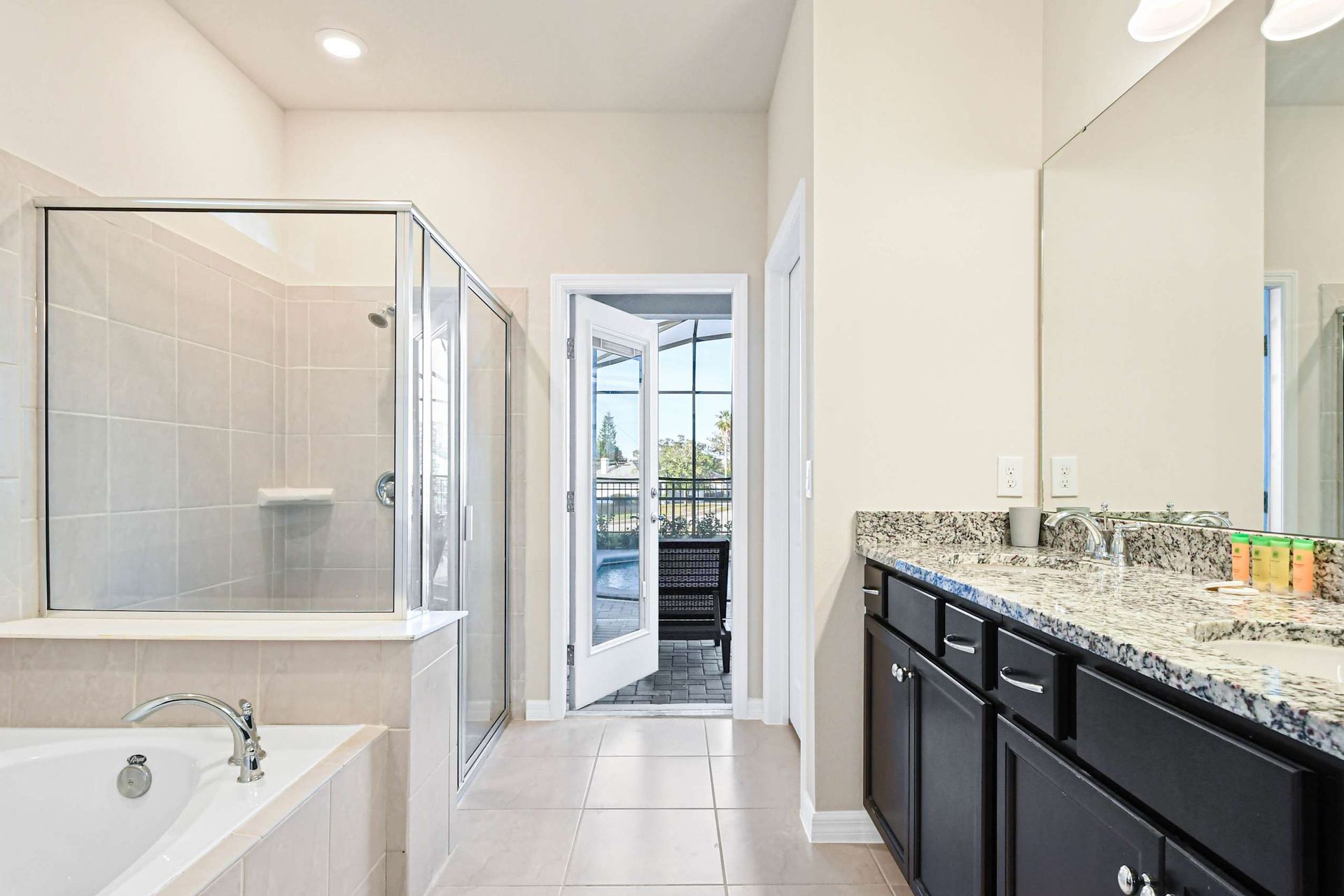 Spacious modern bathrooms with granite counters and sleek walk-in showers.