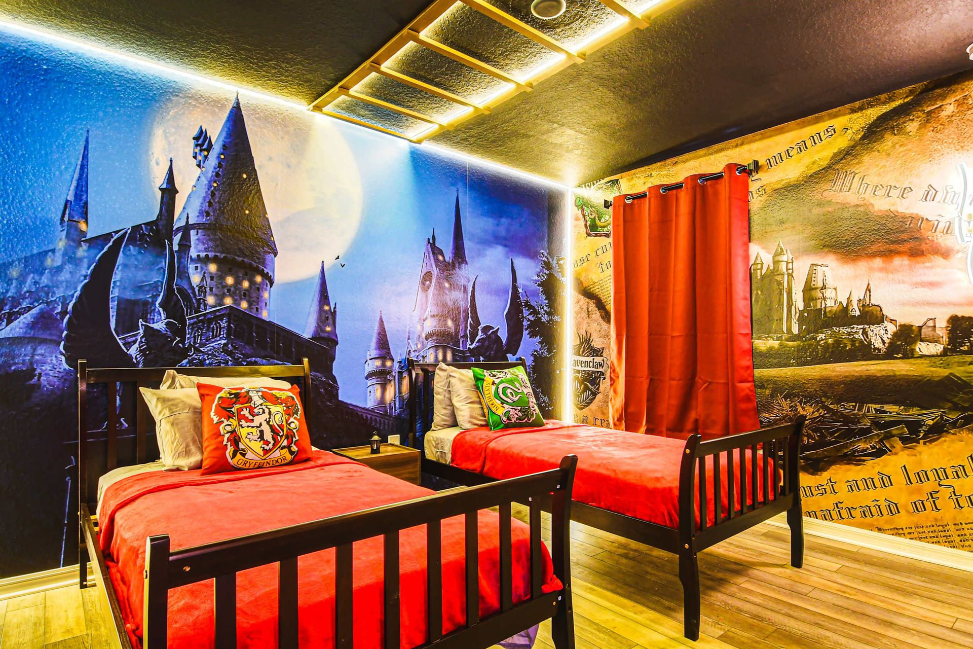Magical wizard-themed room with glowing Hogwarts murals and house crest bedding.