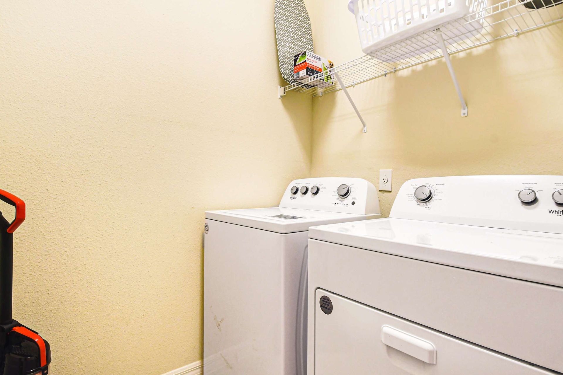 Full laundry room with washer, dryer, shelving, and cleaning essentials included.