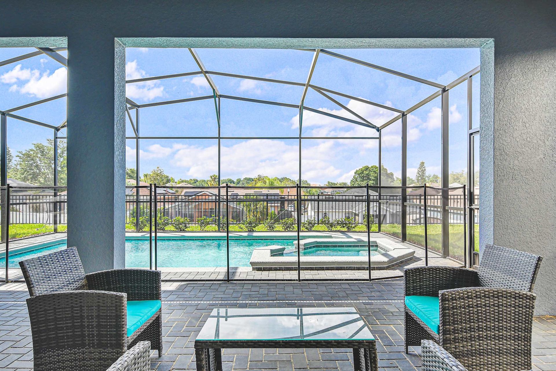 Covered patio with comfy seating, private pool, spa, and screened outdoor views.