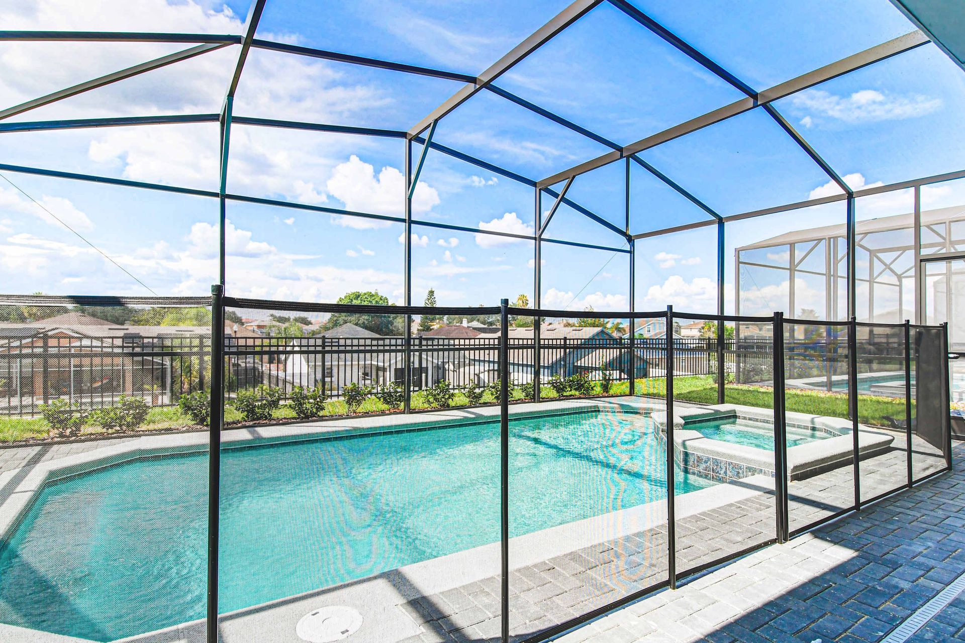 Relax in a private screened pool and spa with child safety fence and sunny views.