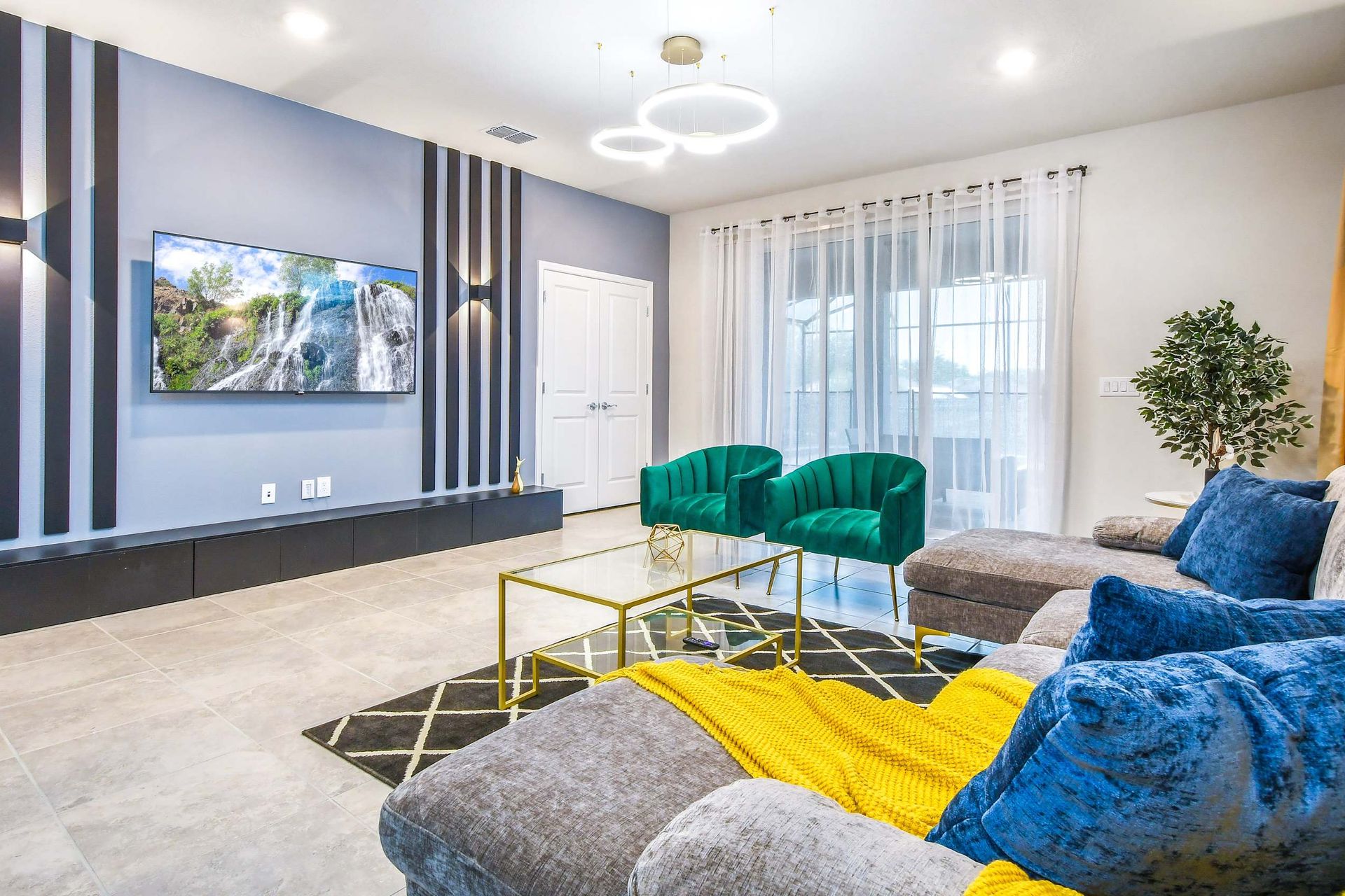 Modern living room with bold accents, plush seating, and elegant lighting design.