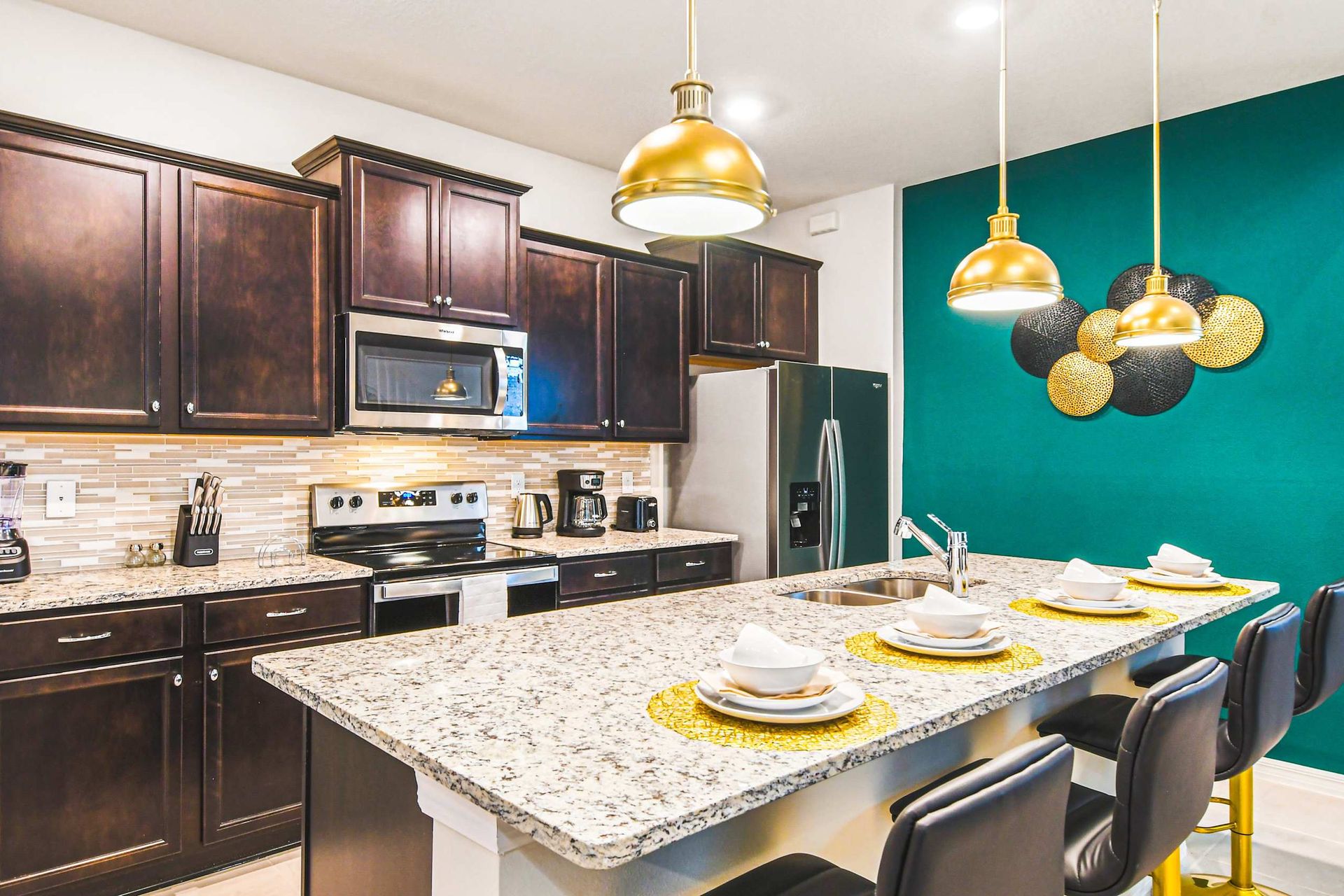 Modern kitchen with granite counters and gold accents—cook in style and comfort!