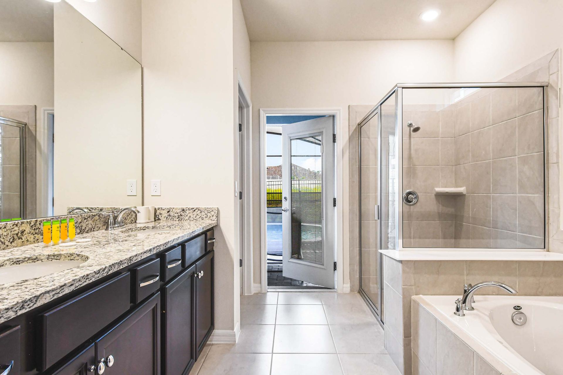 Spacious ensuite with dual sinks, walk-in shower, soaking tub, and pool access!