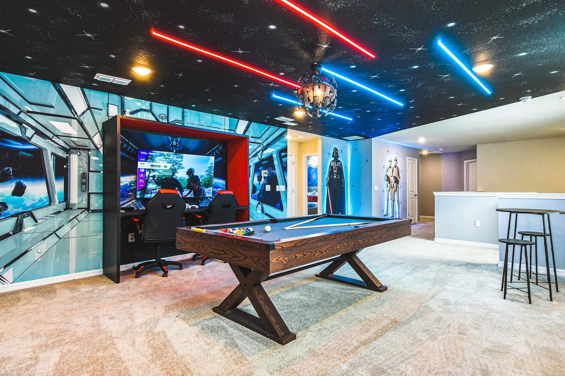 Epic Star Wars game loft with pool, gaming stations, and lightsaber ceiling glow!