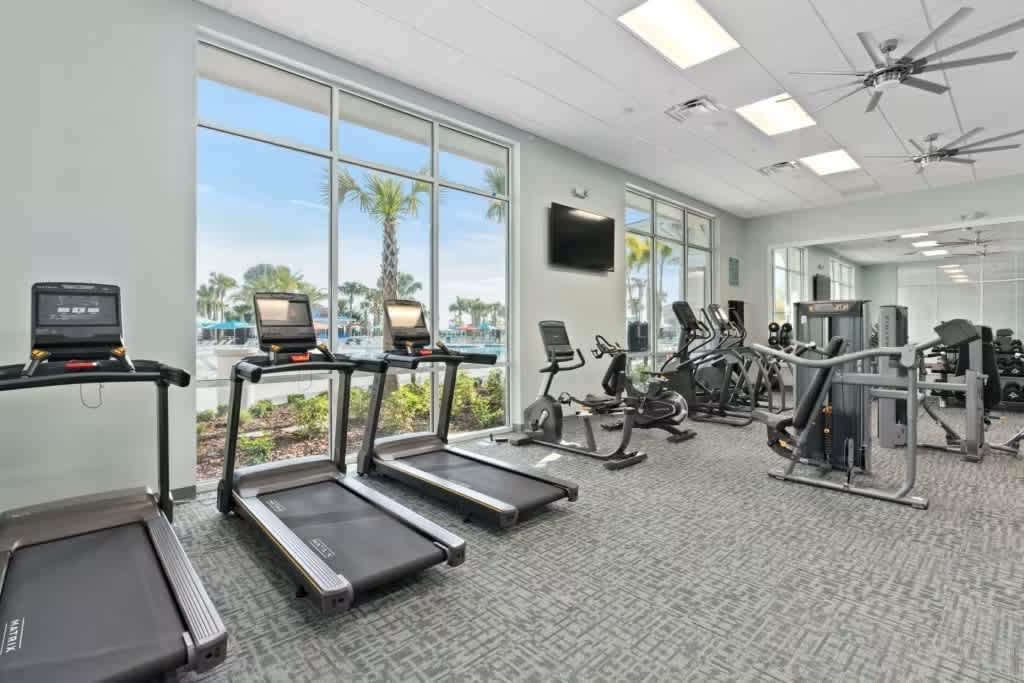 Enjoy your workouts with a view! Bright, modern gym overlooking resort amenities.
