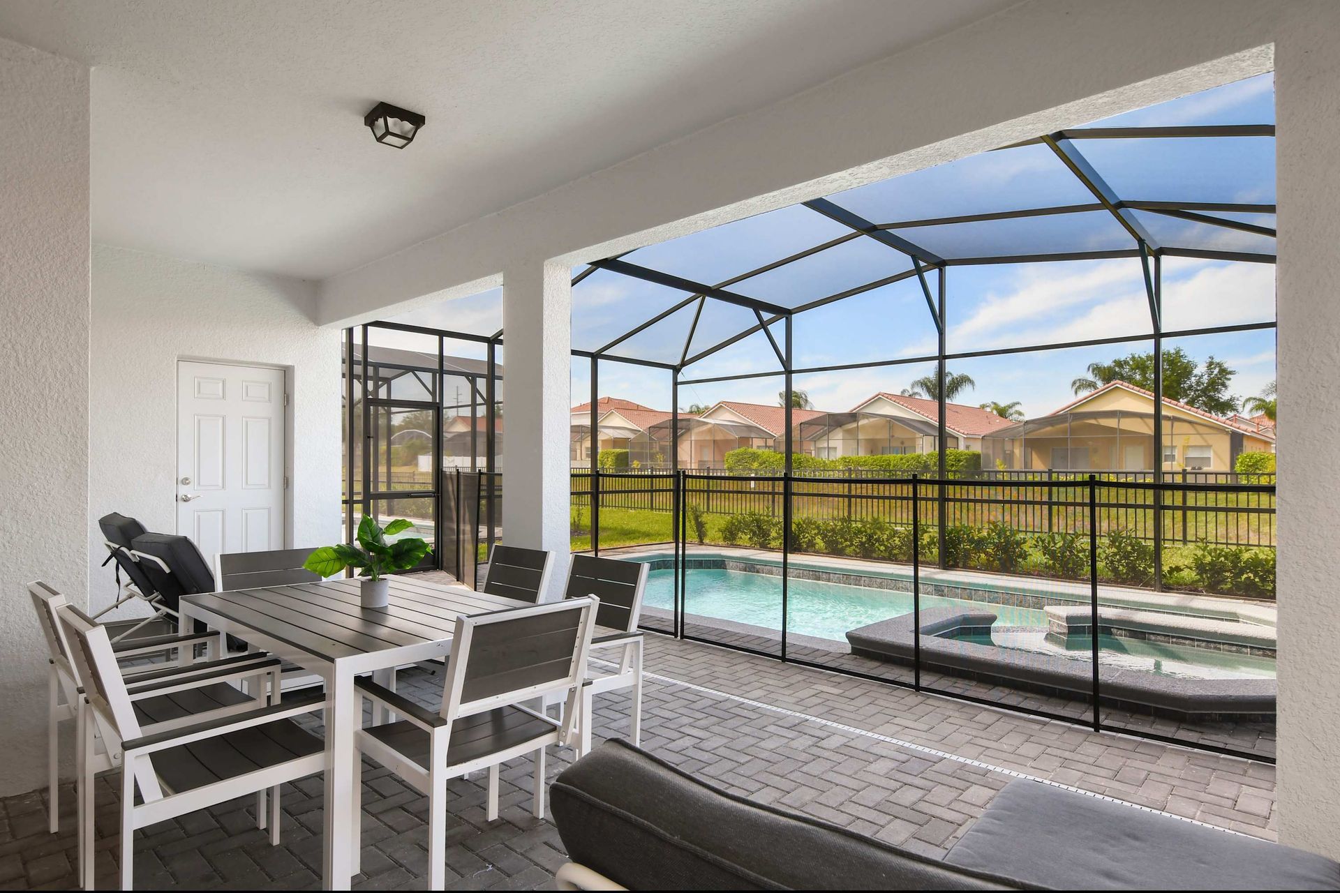 Relax poolside in this screened patio with dining area and private spa retreat.