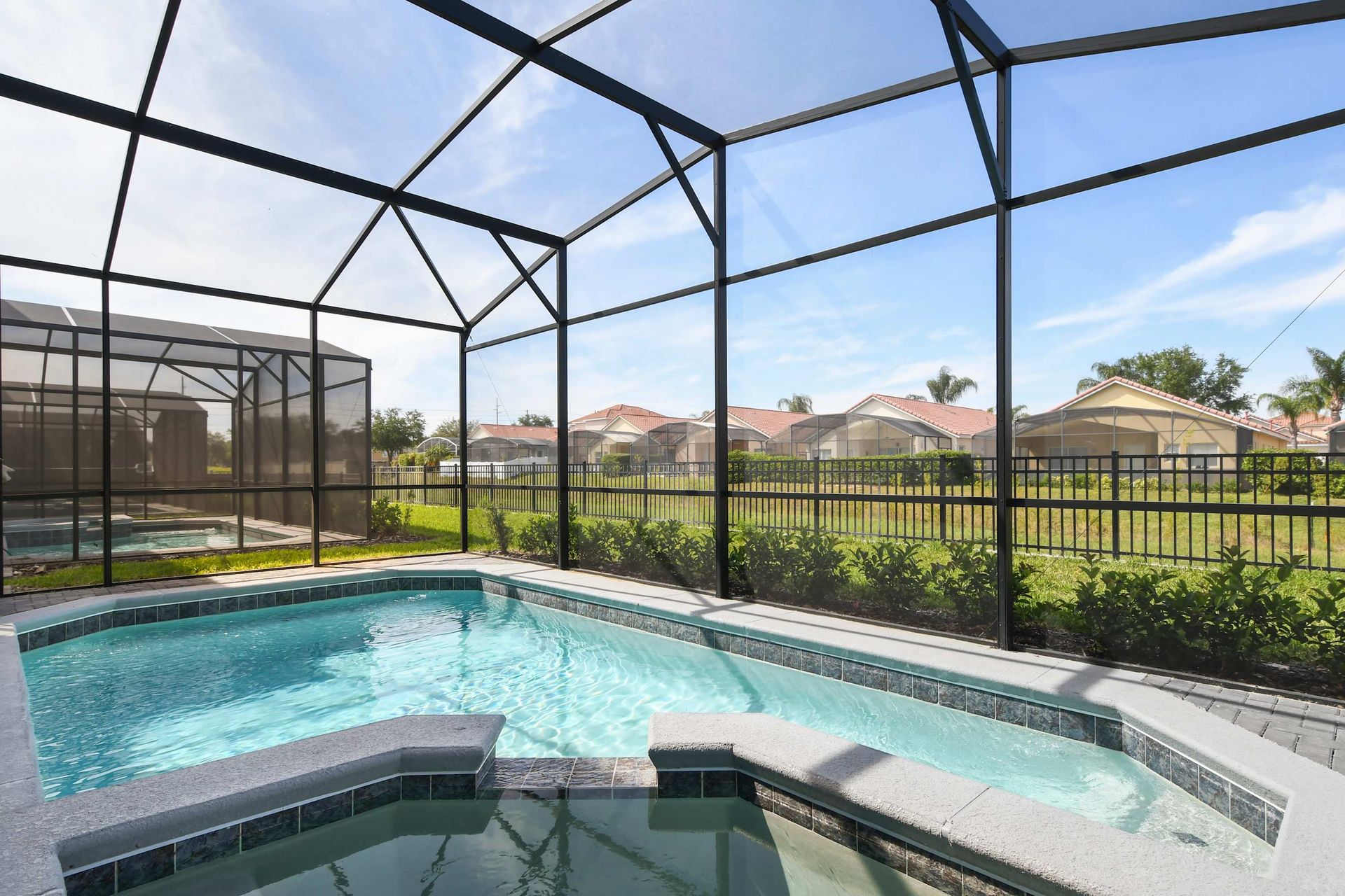 Relax in a screened-in private pool and spa with peaceful views and sunny skies.